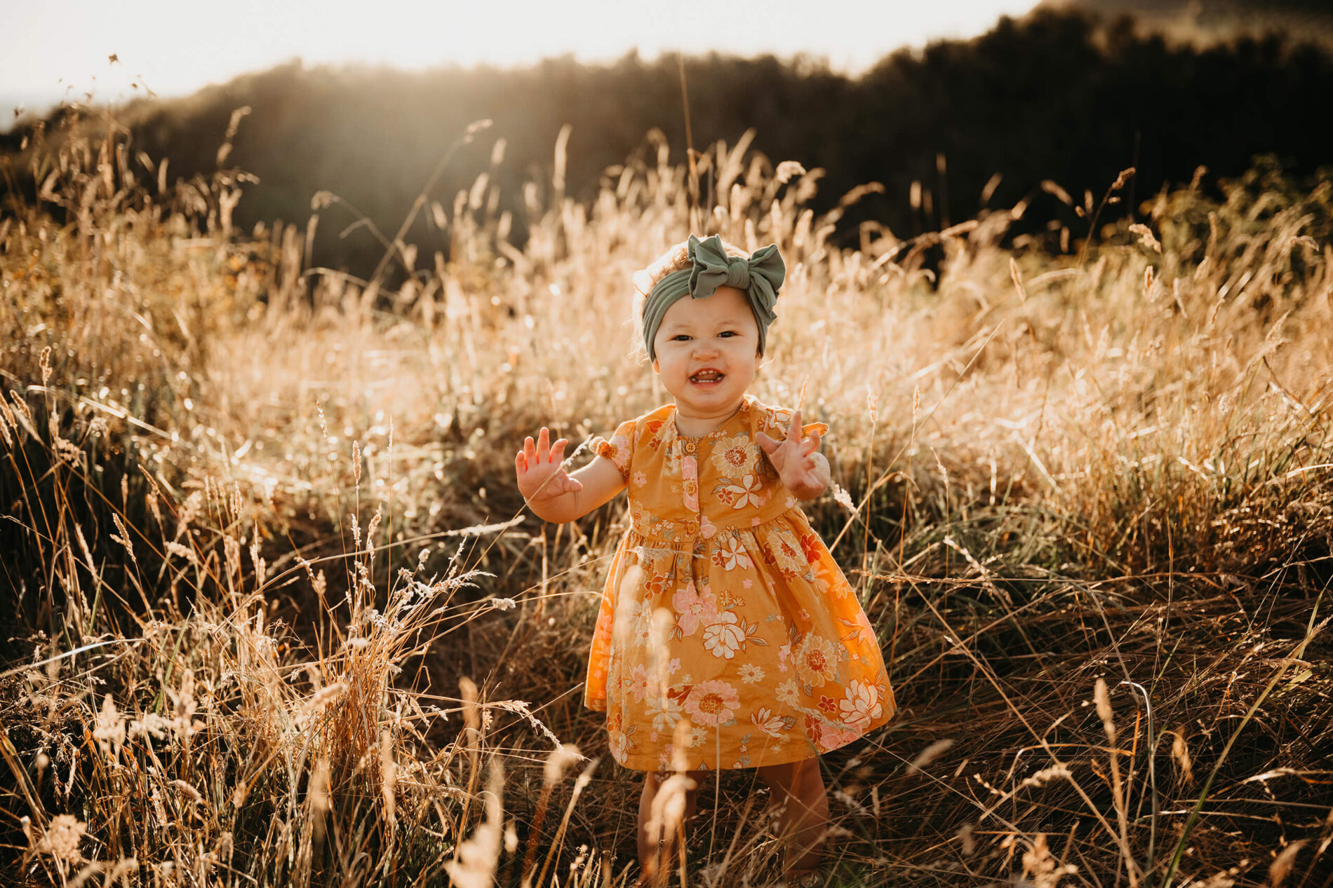 A baby girl playing in a field in Whidbey Island, WA