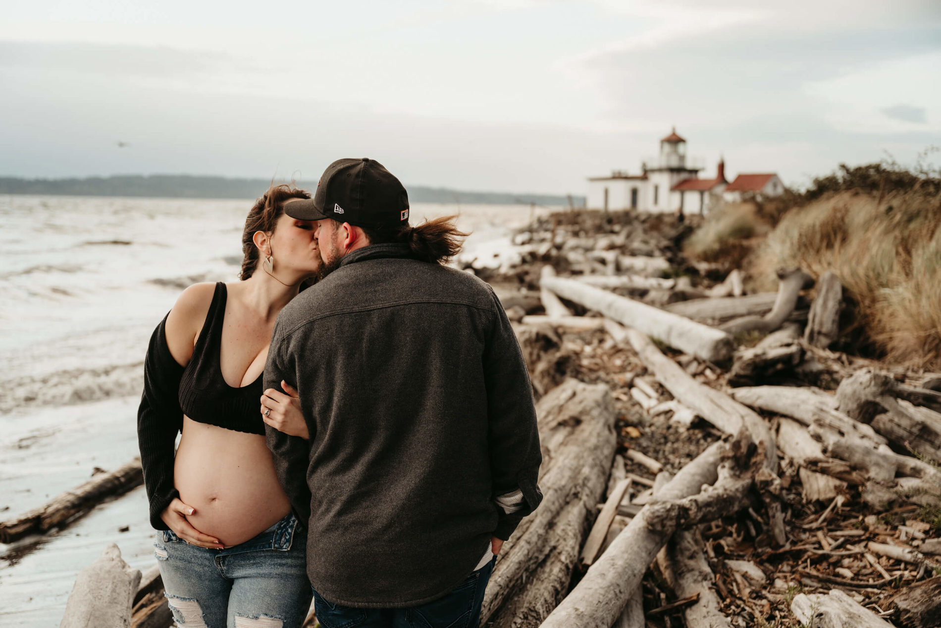 Pregnant woman being kissed by her husband in Seattle park
