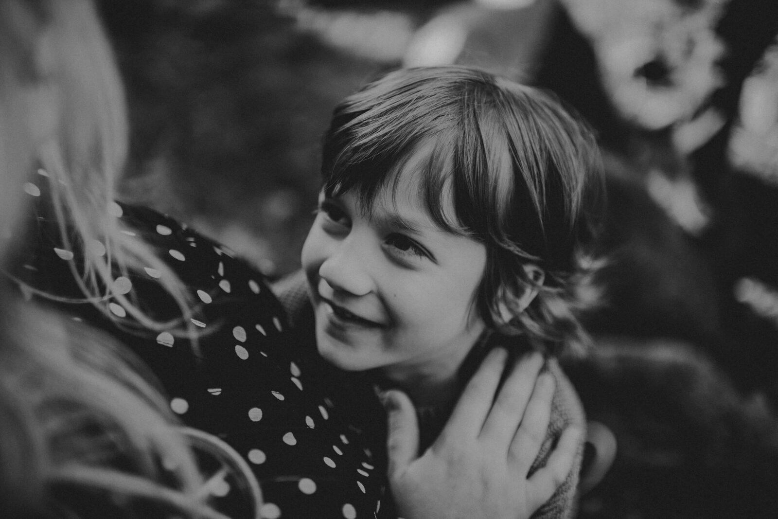 A close-up of a boy looking up lovingly at his mom