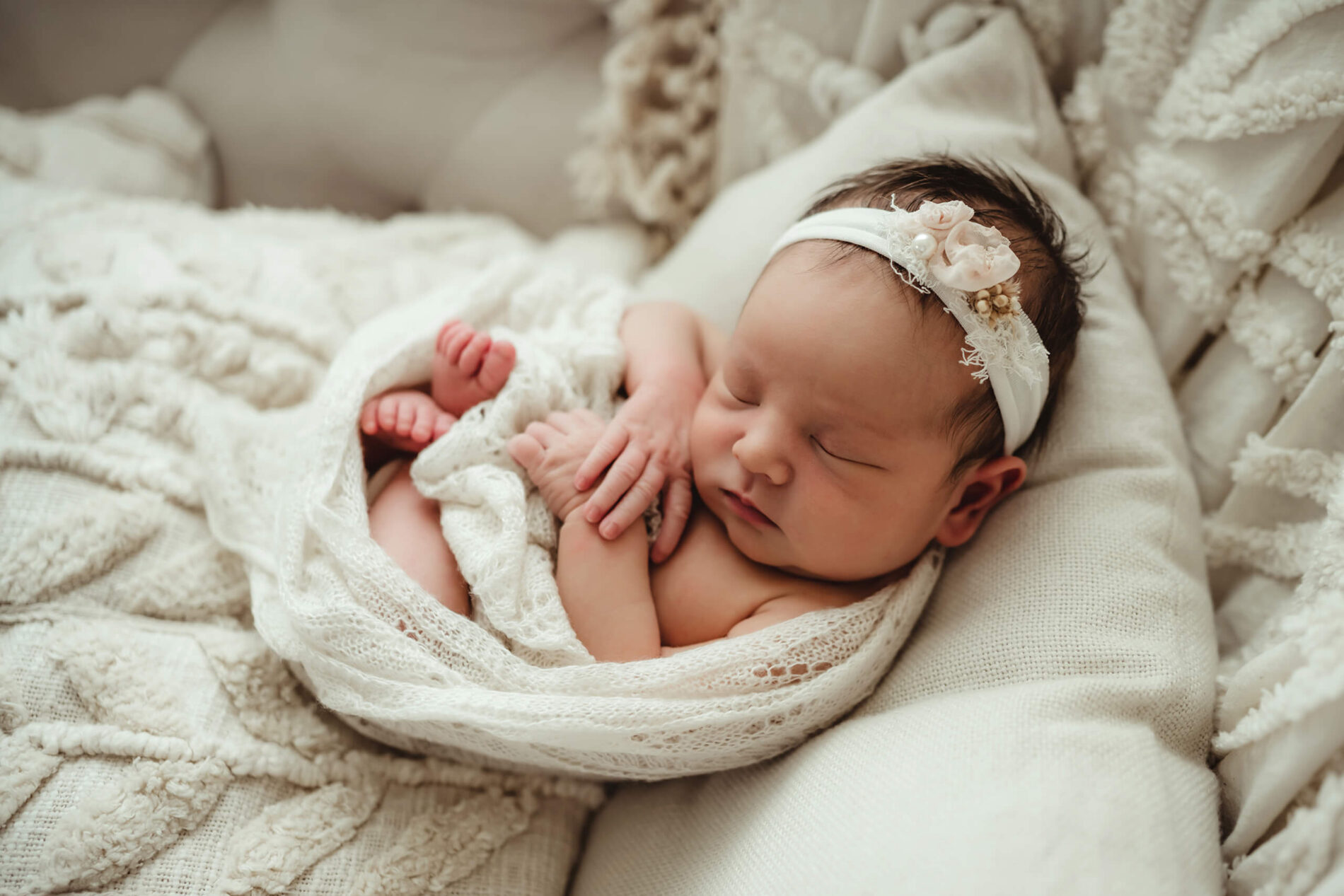 Close-up of a newborn girl, peacefully sleeping