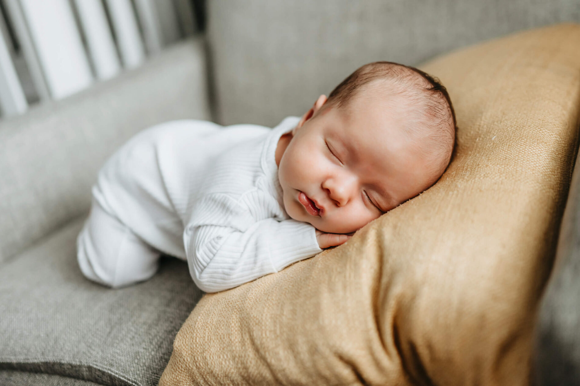 Newborn boy, sleeping cozily on an armchair