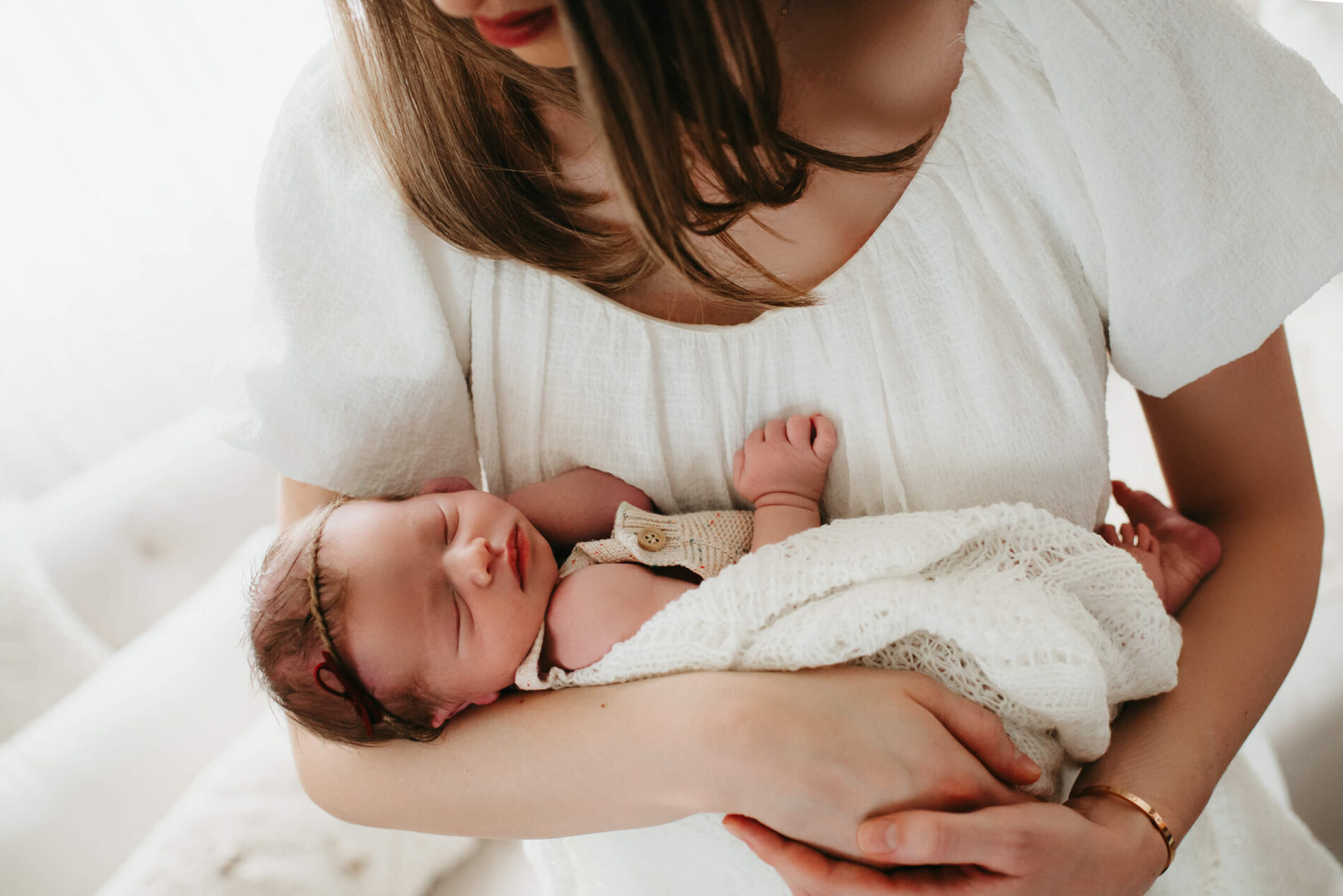 Mom cradling her newborn baby girl