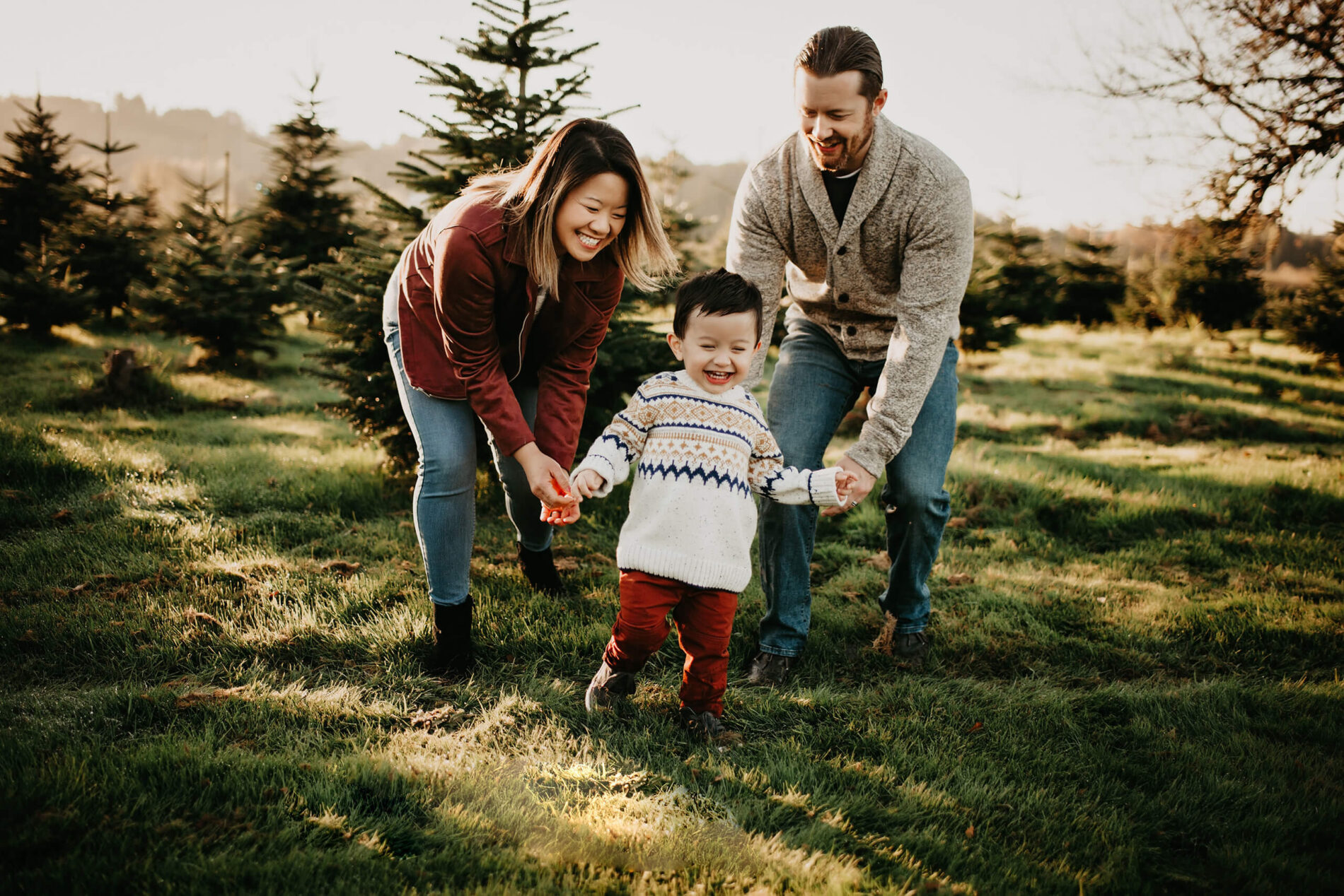 A lifestyle family portrait at a Christmas tree farm