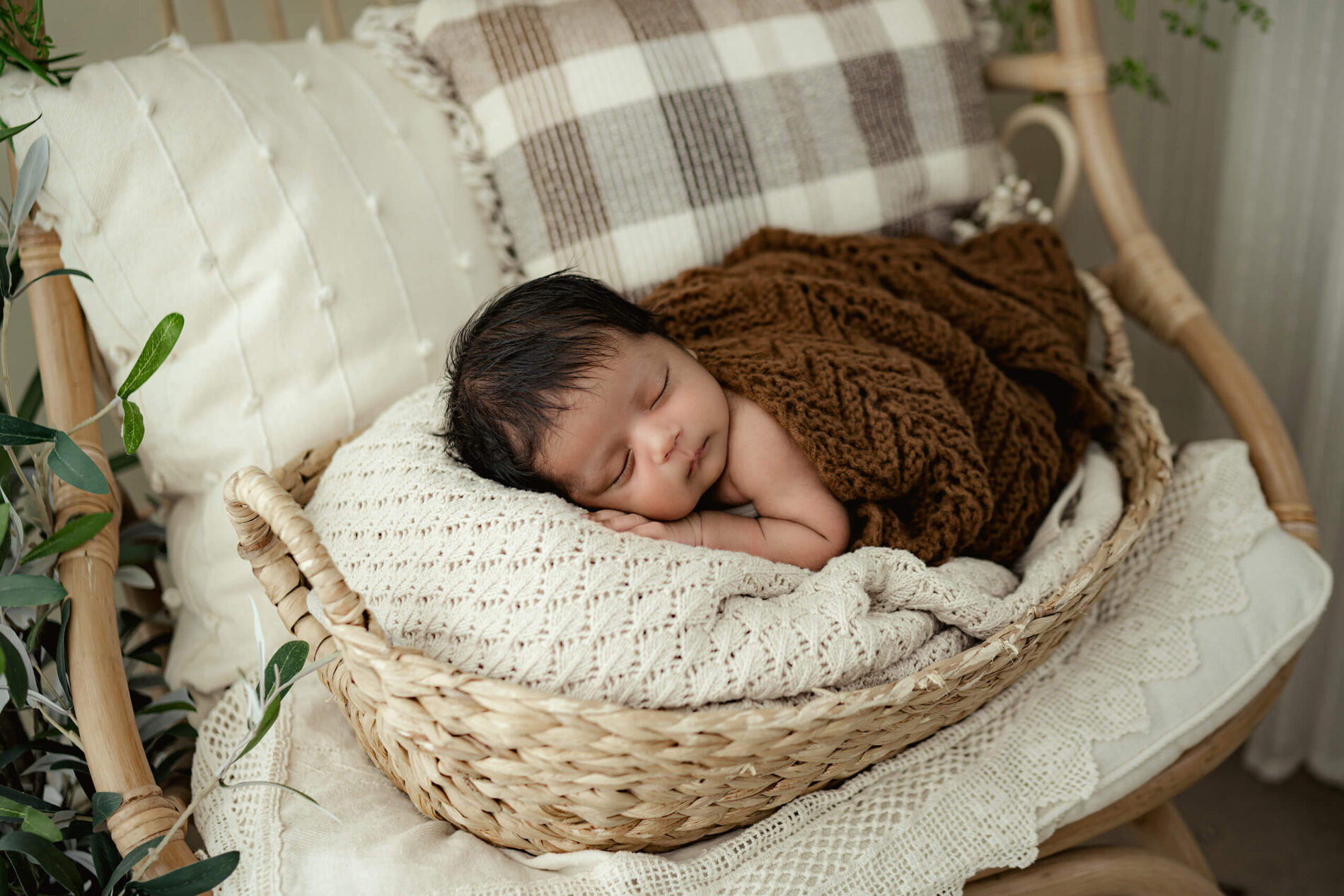 Newborn photography of a boy sleeping in a basket
