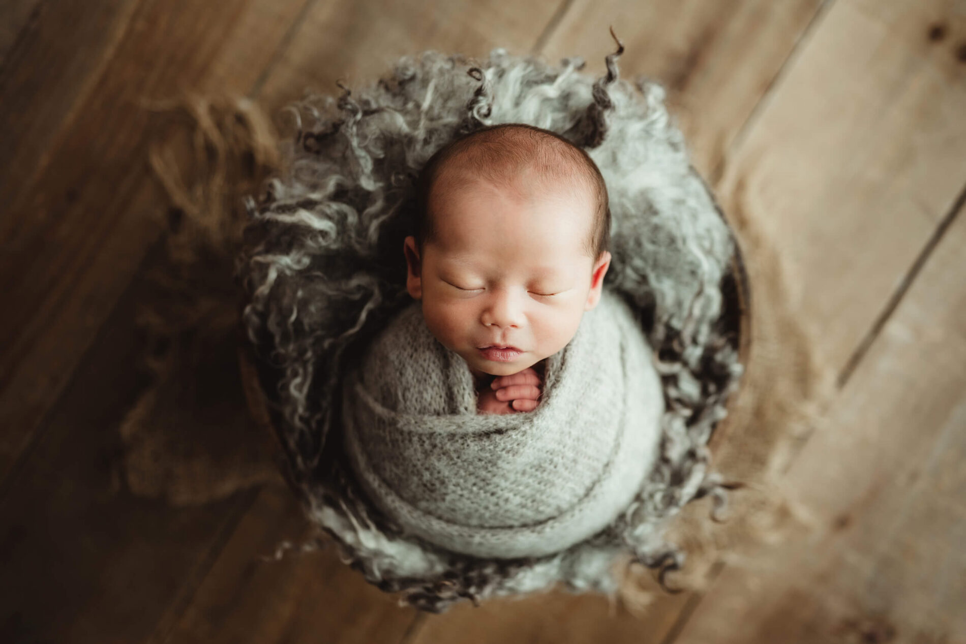 Newborn photography session with a beautifully wrapped baby boy