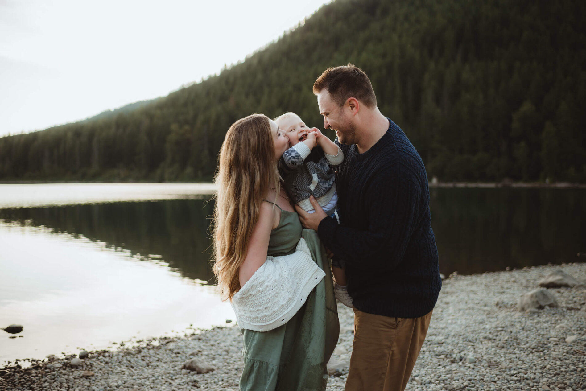 A moment during a family photoshoot at the beach with mountains in the background
