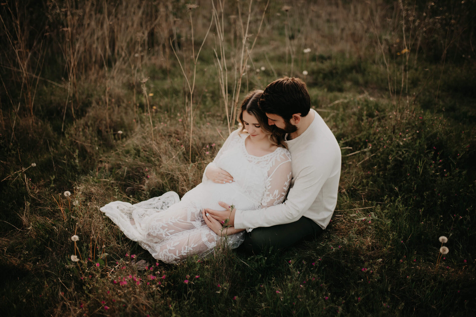 Outside couple maternity photoshoot in the Seattle area with husband lovingly hugging his wife