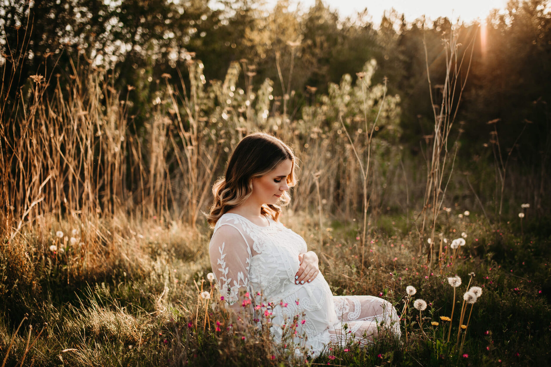 Outdoor maternity photoshoot in the Seattle area with mom looking down at her belly