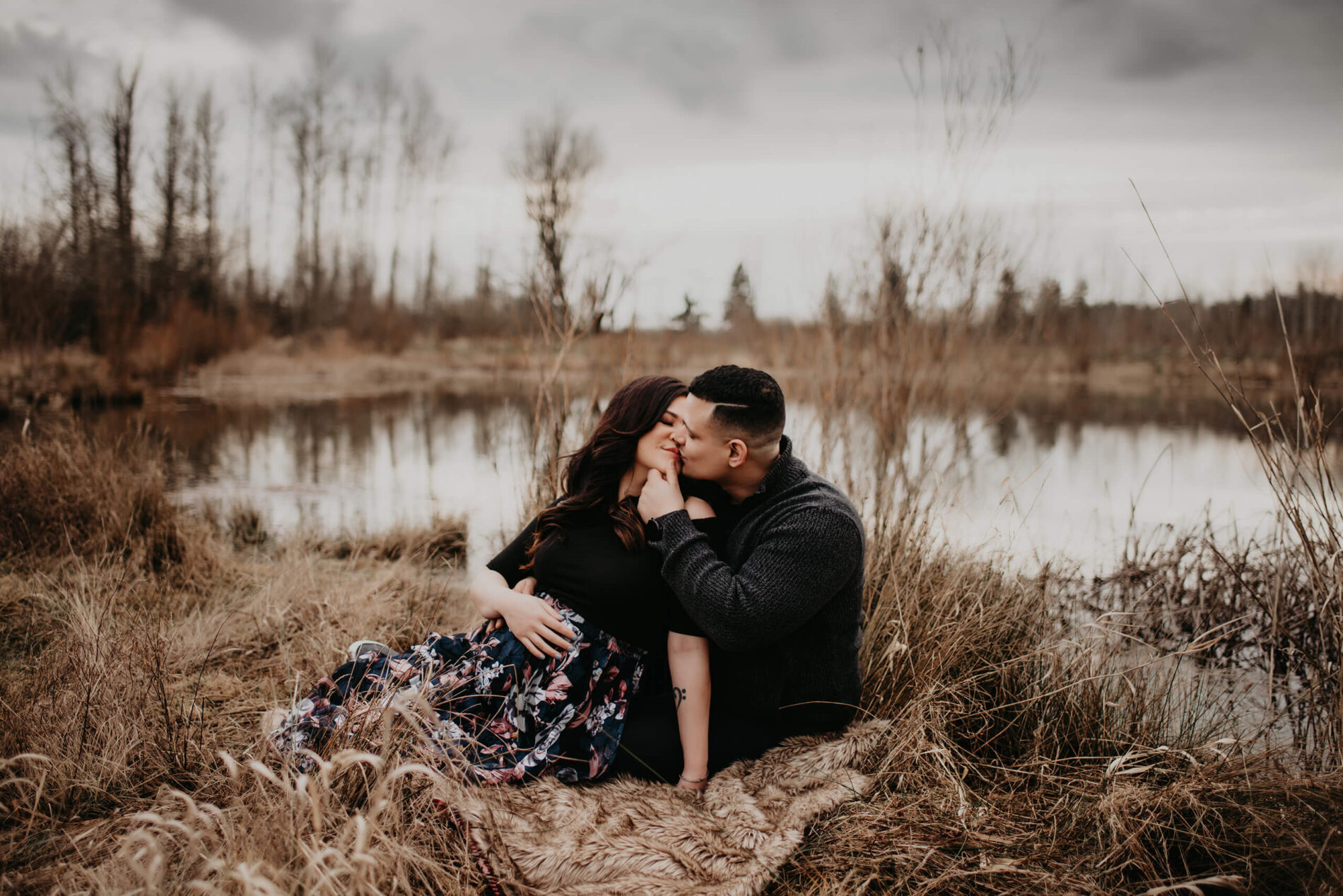 A couple kissing during a maternity photoshoot in the Seattle area