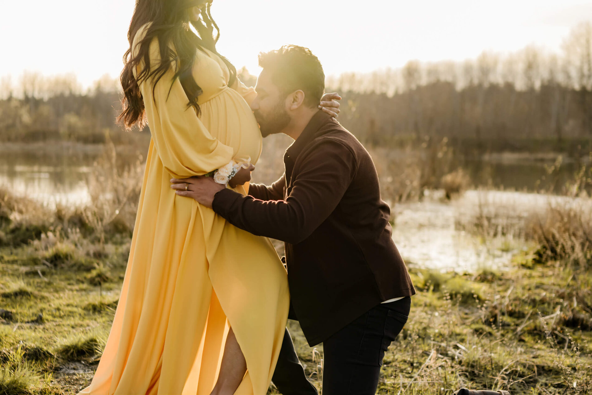 Husband kissing his wife's belly during a maternity photo session in the Seattle area