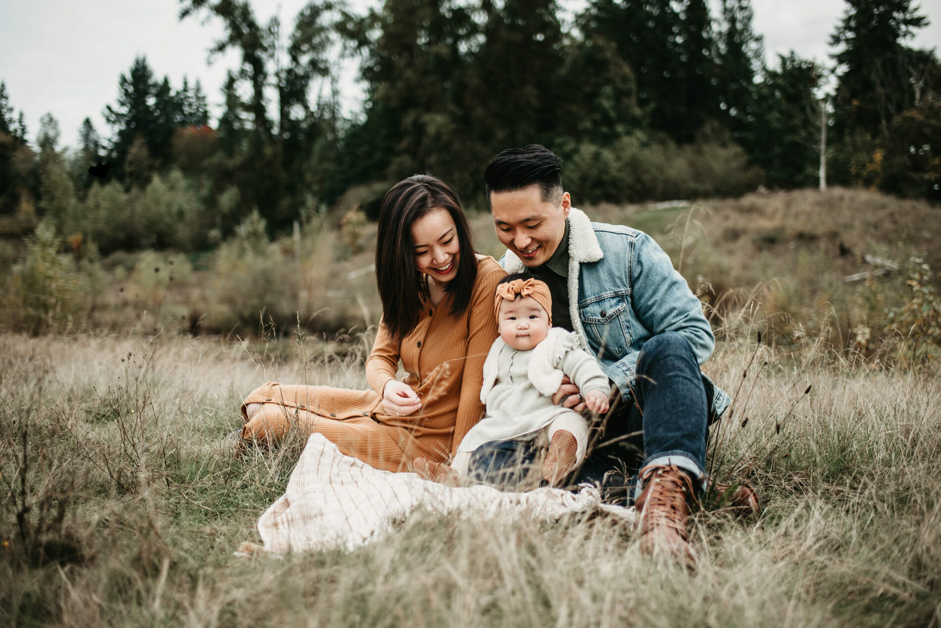 Family photo session of two young parents with their toddler daughter