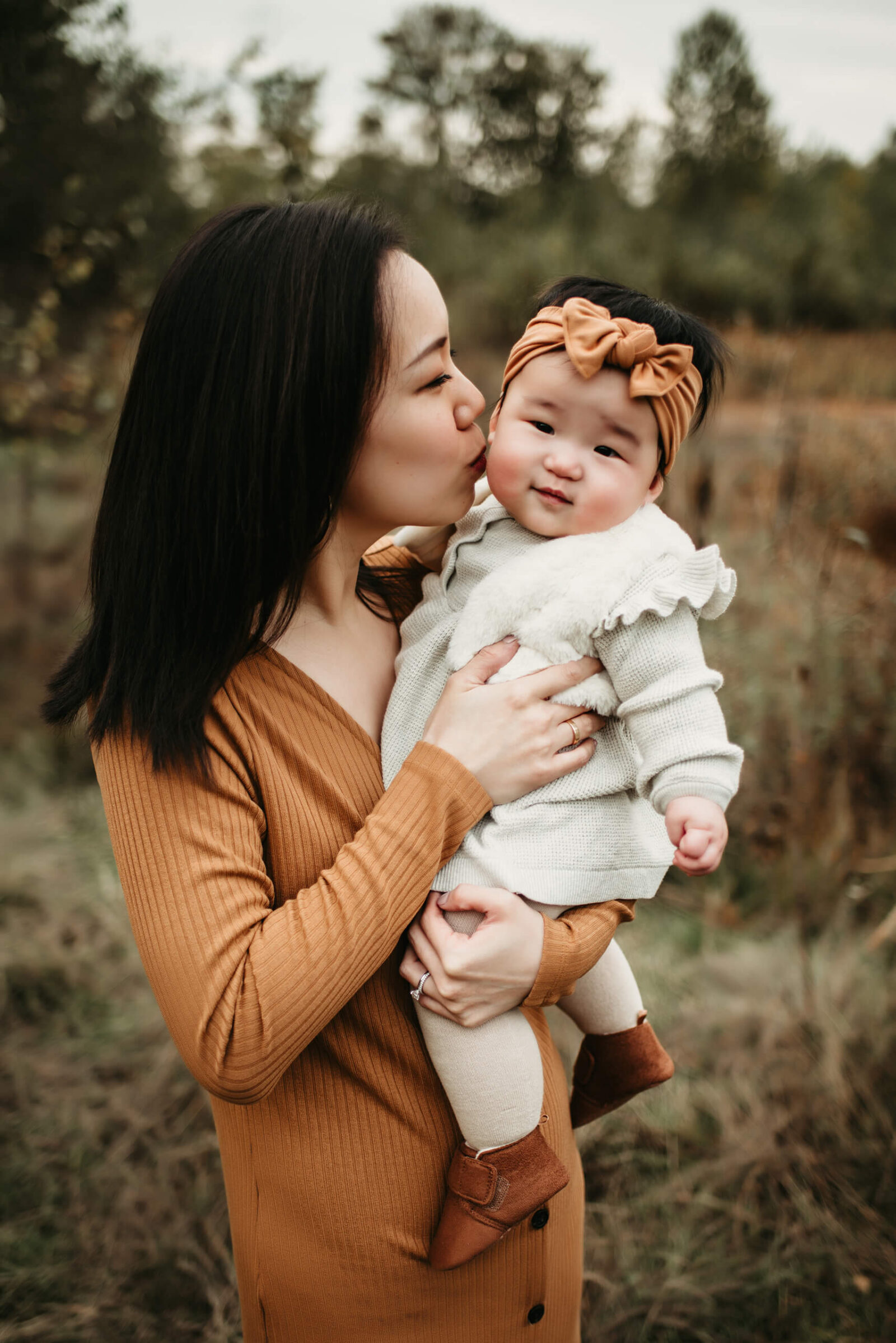 Family lifestyle portrait of mom with her toddler daughter in natural scenic setting