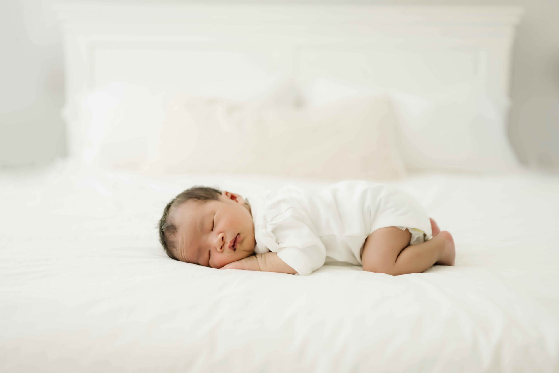 Unposed newborn photography ideas on a bed in your home