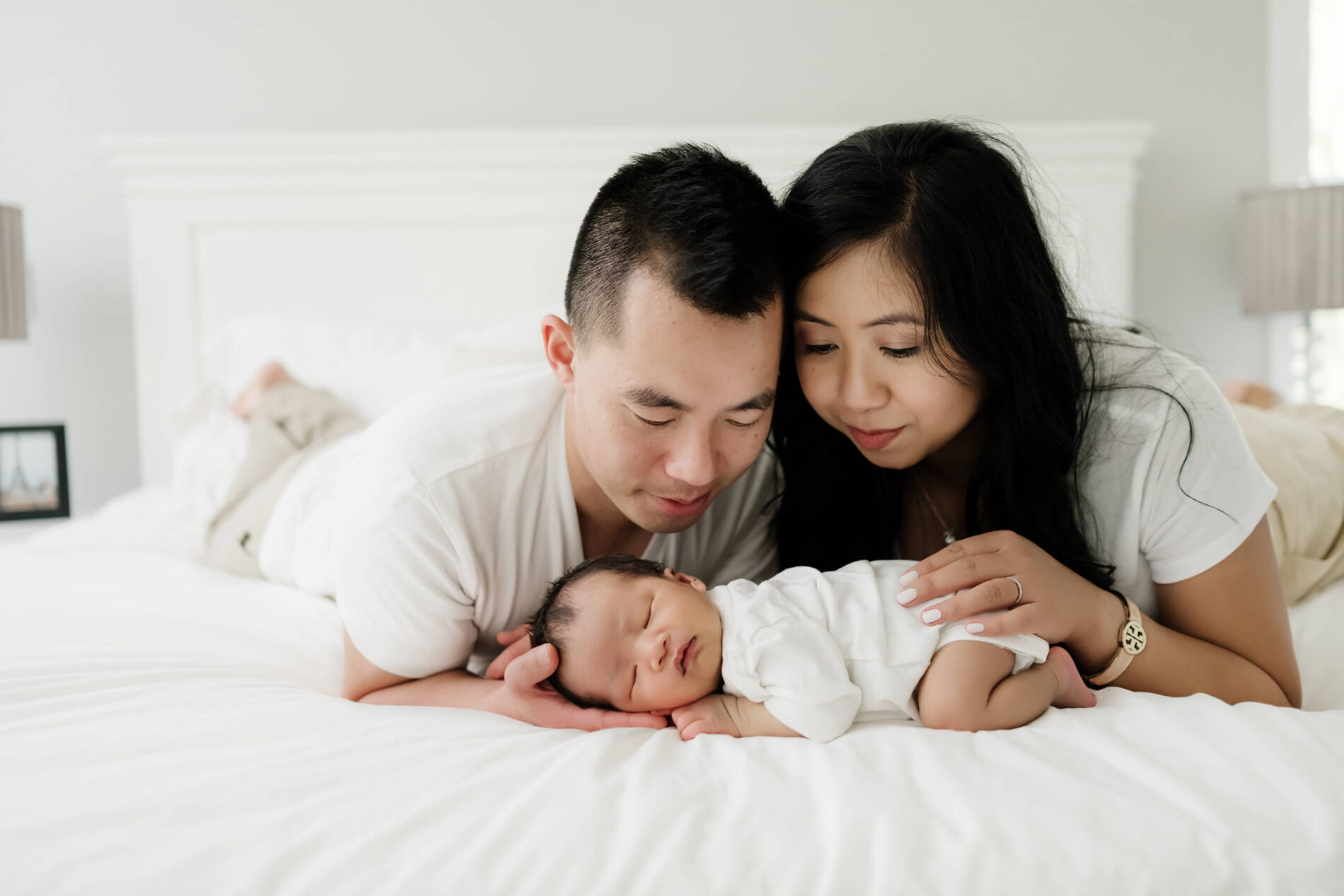 Unposed newborn photography with parents during in home photo shoot