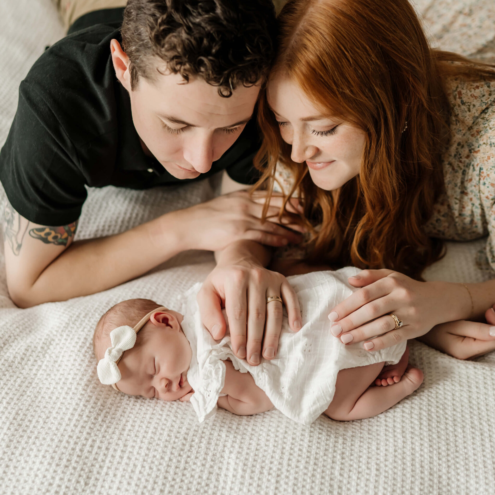 Mom and dad posing idea with baby girl during in home newborn photo shoot