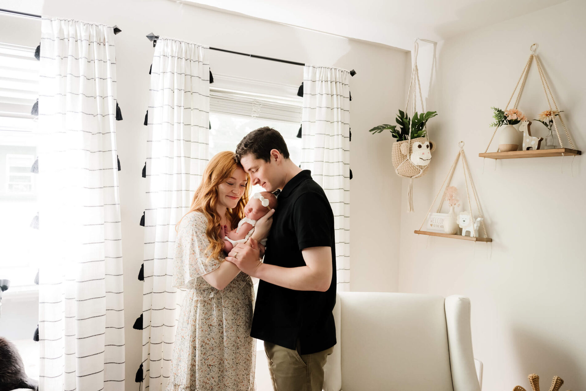 Mom and dad posing idea with baby girl during in home newborn photo shoot