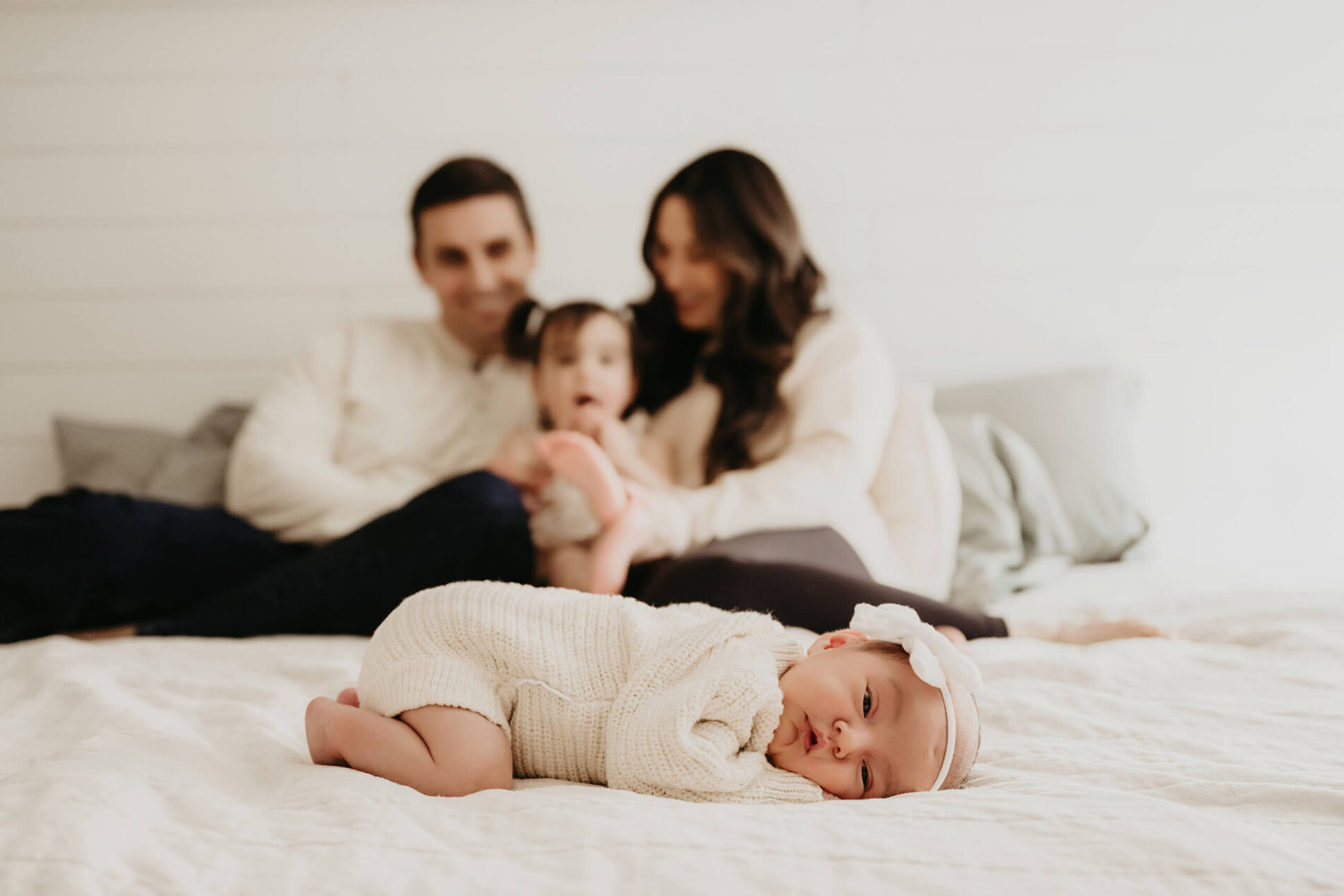 Family newborn photo with sibling with a focus on the baby girl