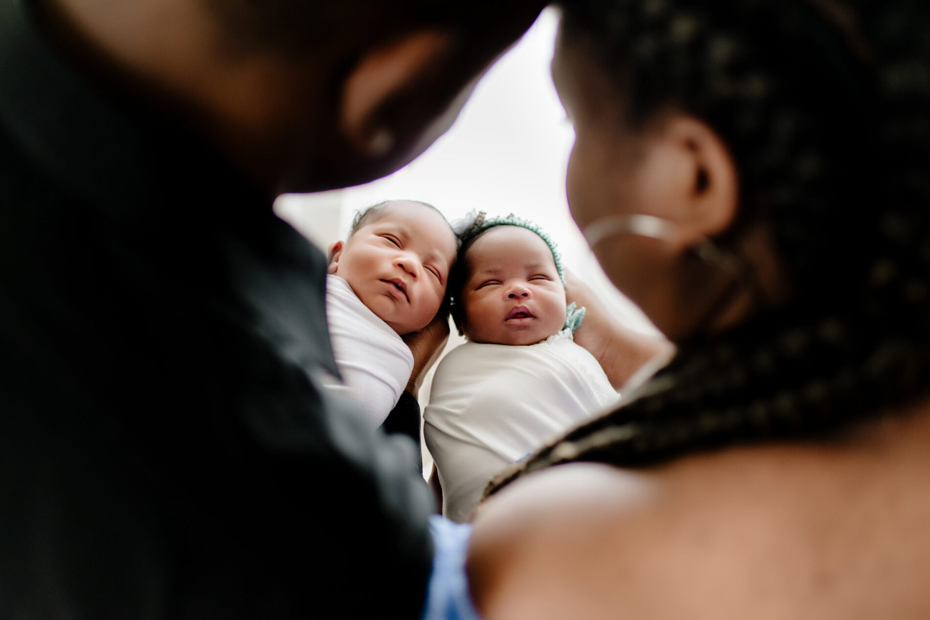 Twin newborn photo shoot in a studio with parents