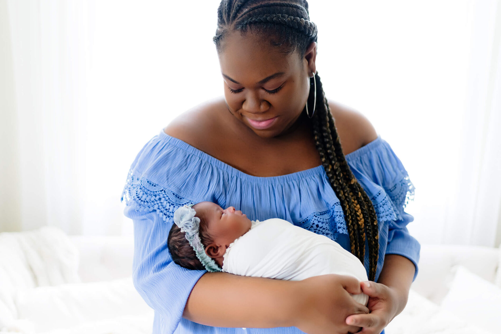 Twin newborn photo shoot in a studio with mom