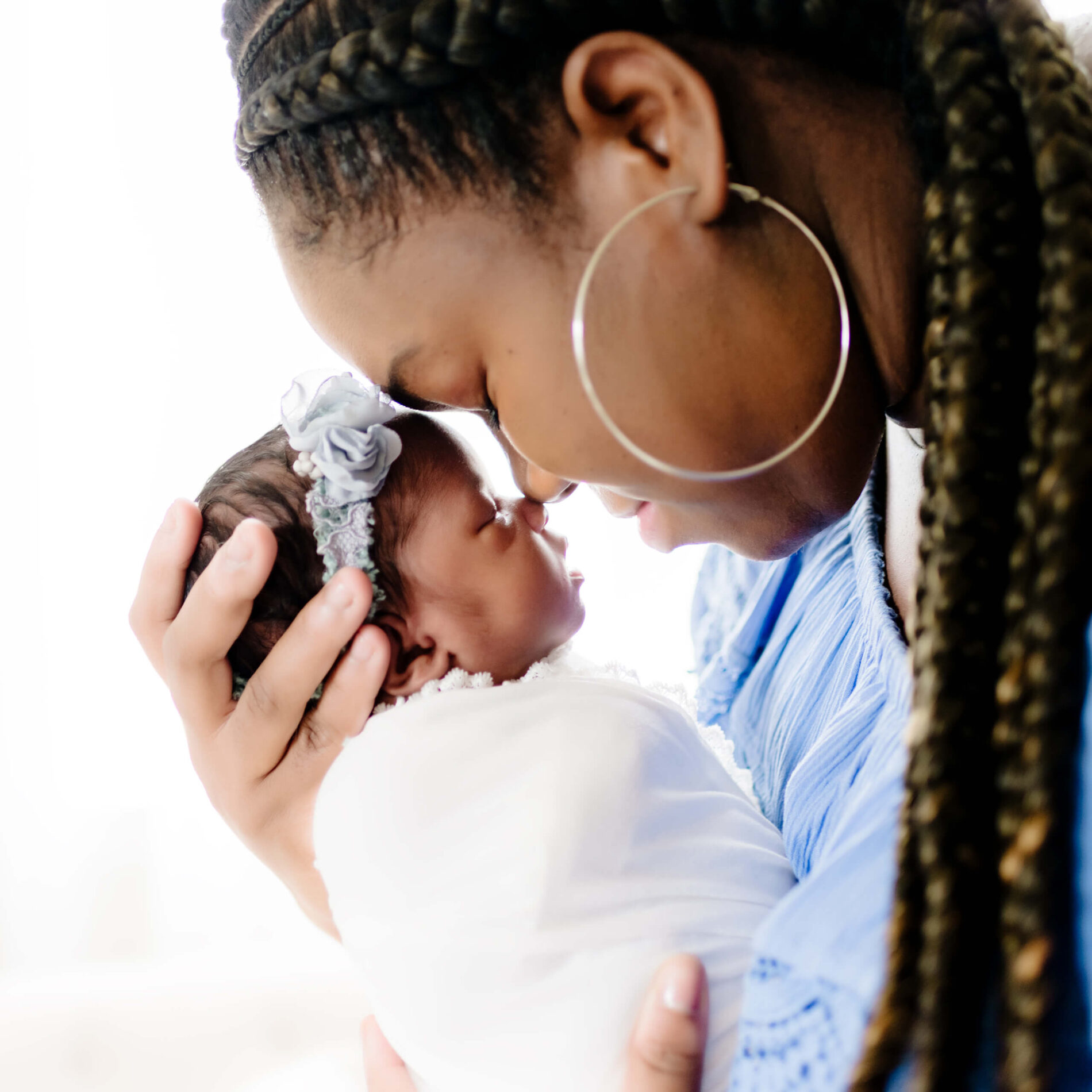 Twin newborn photo shoot in a studio with mom