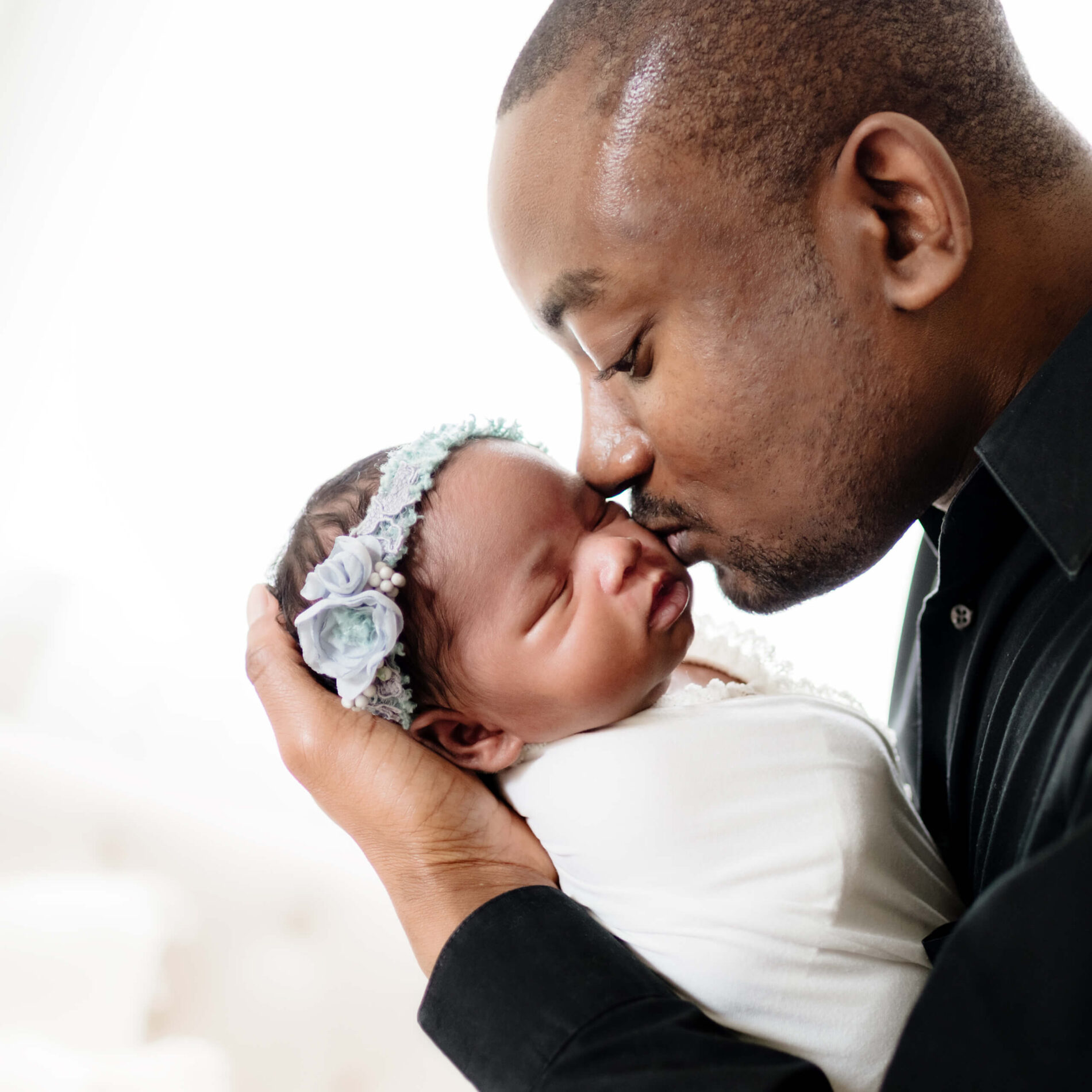 Twin newborn photo shoot in a studio with dad