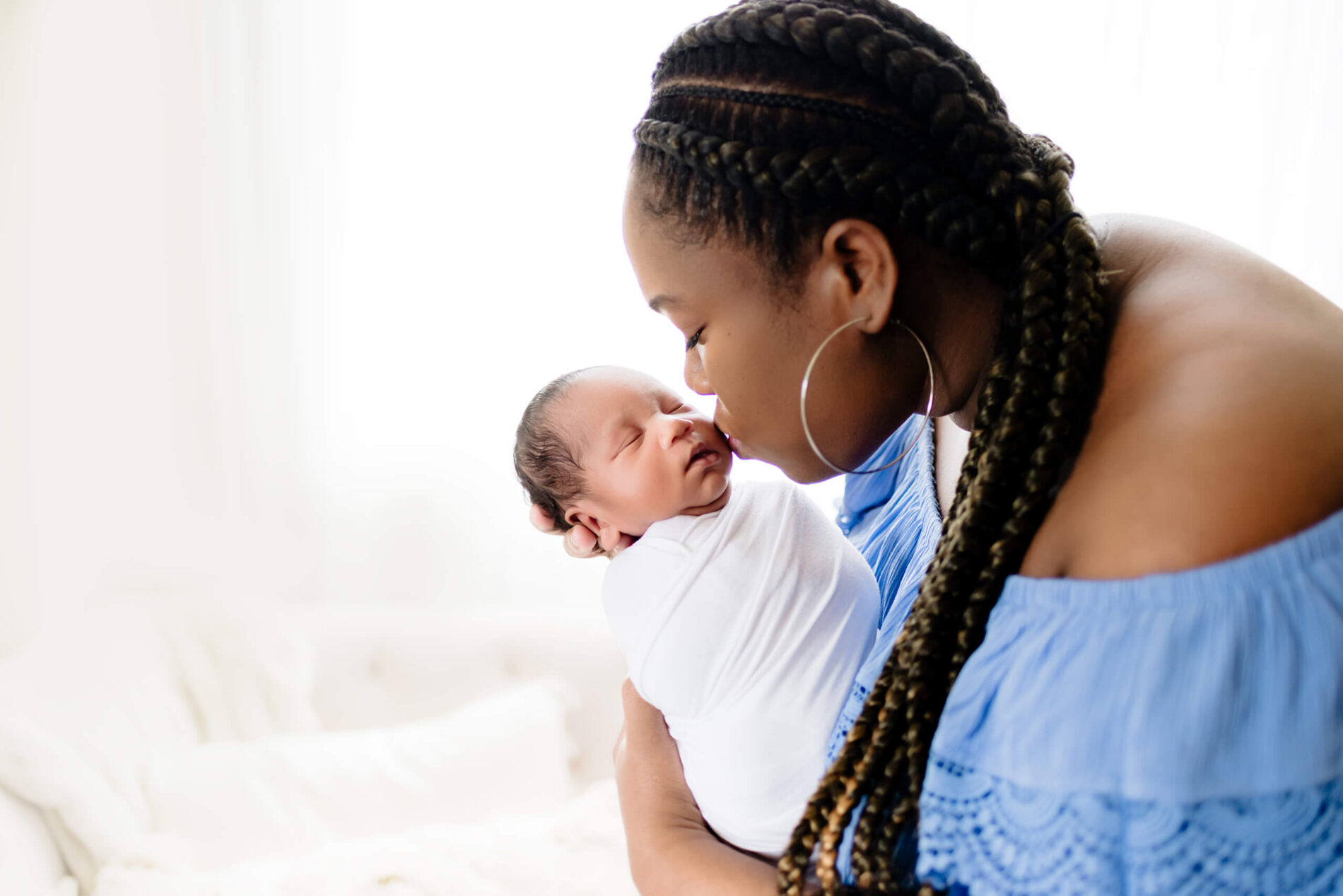 Twin newborn photo shoot in a studio with mom