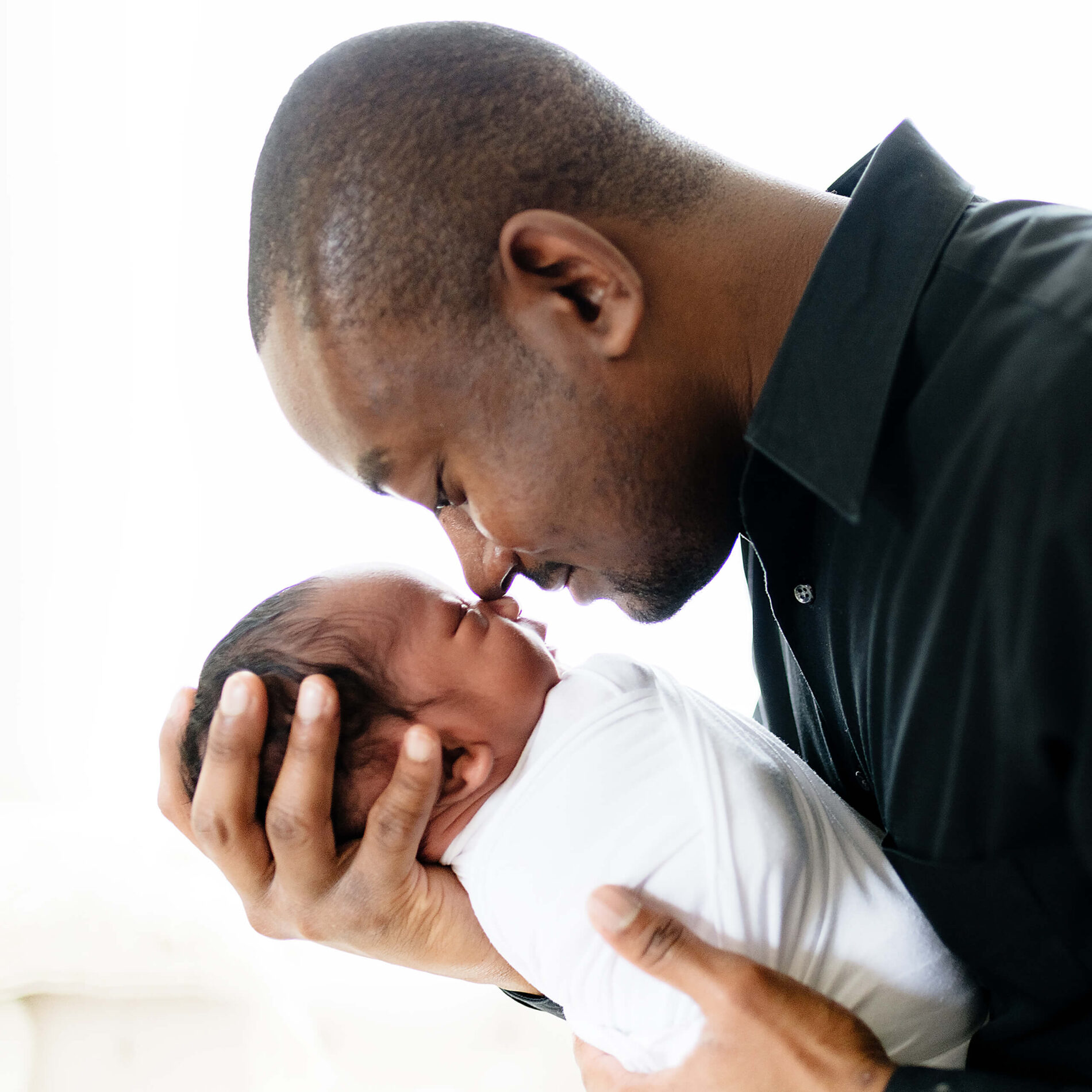 Twin newborn photo shoot in a studio with dad