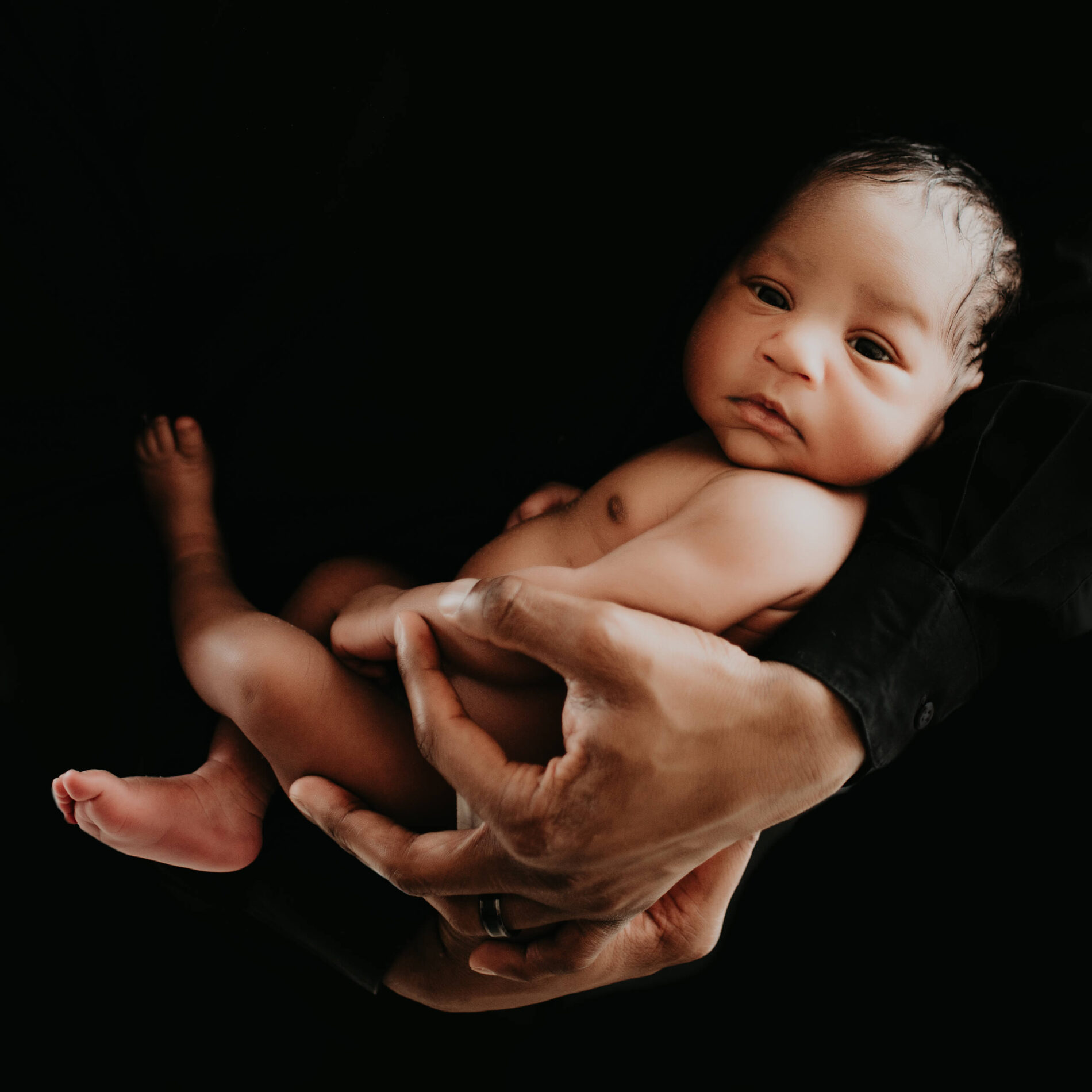 Twin newborn photo shoot in a studio with dad