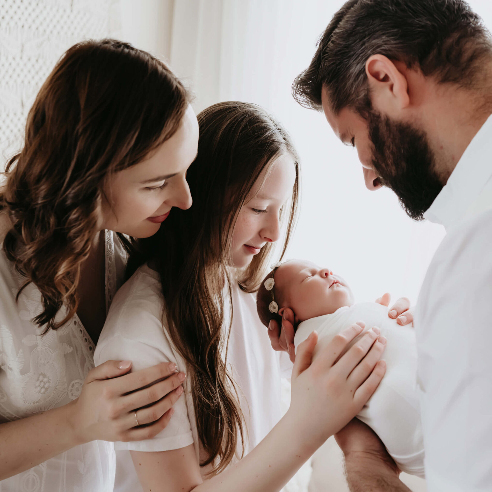 Newborn family photo idea with mom, dad, and big sister