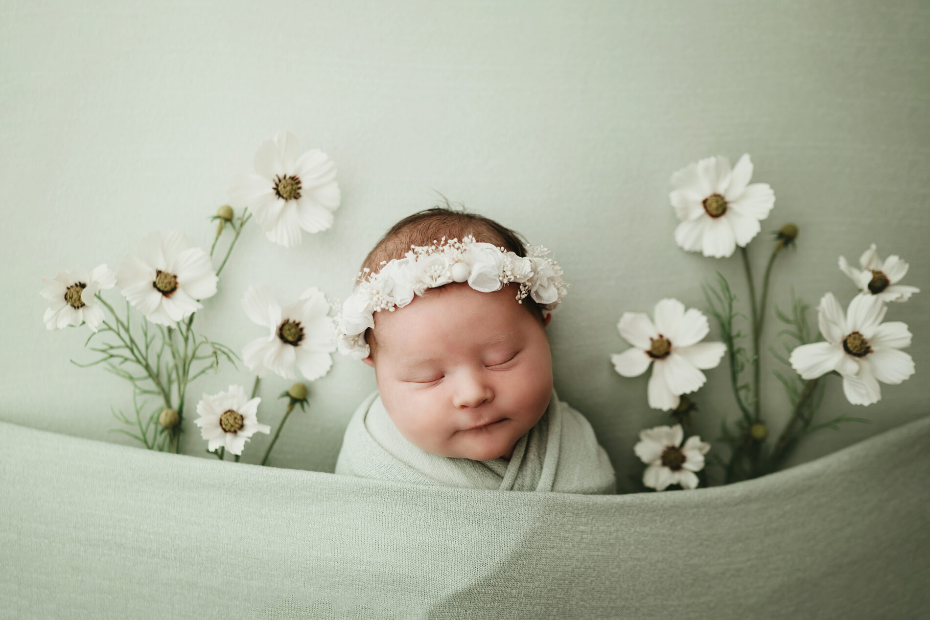 Unique newborn photo of baby girl with flowers