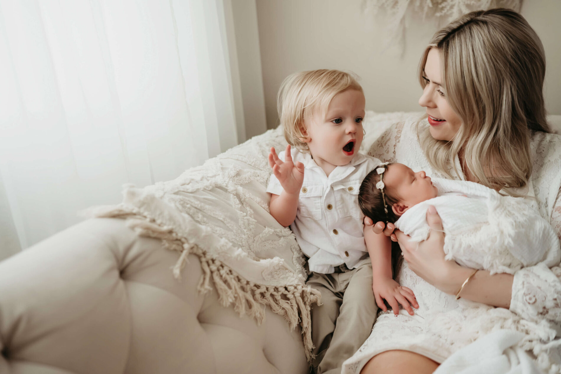 A moment during newborn family photo shoot with toddler