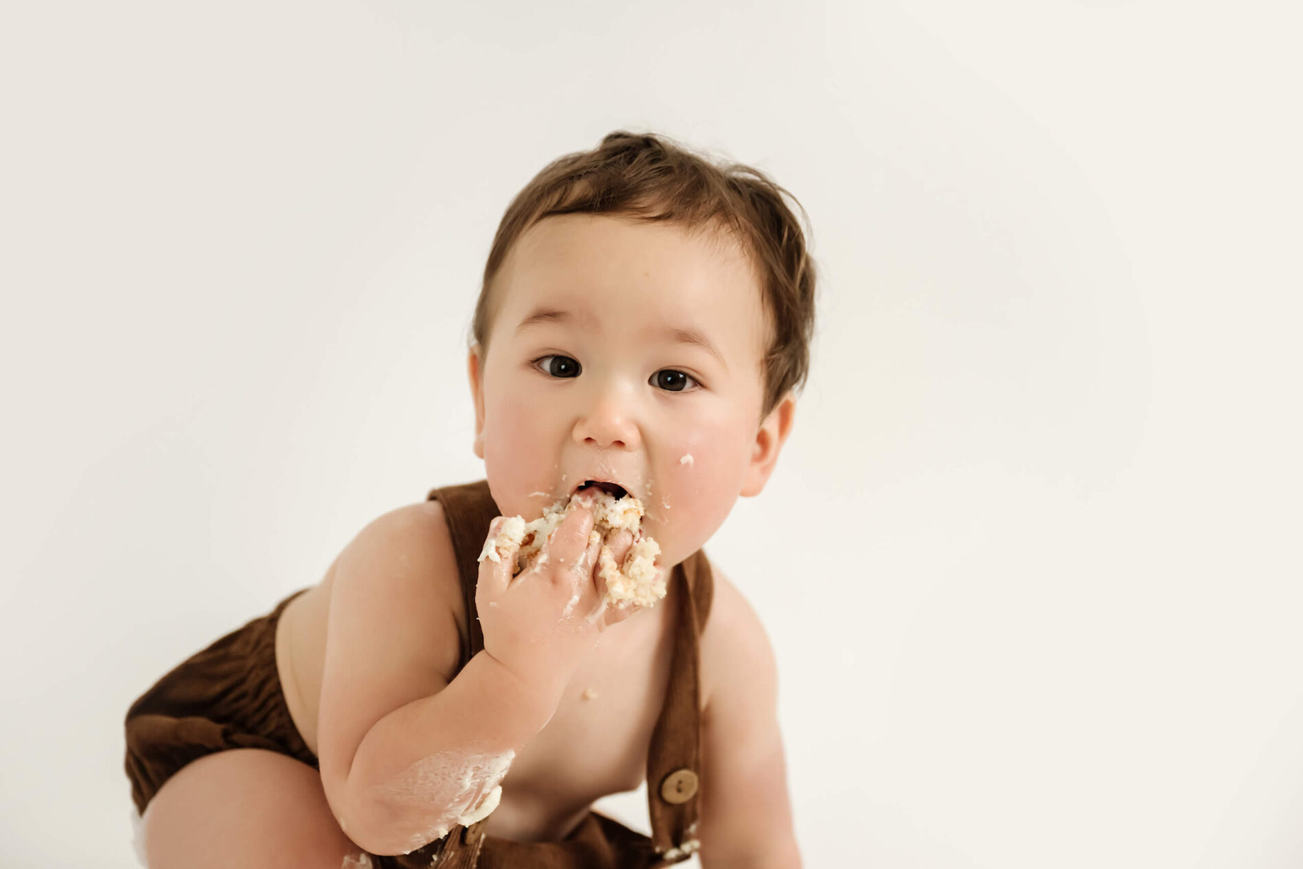 A moment during a cake smash session in a Seattle area studio