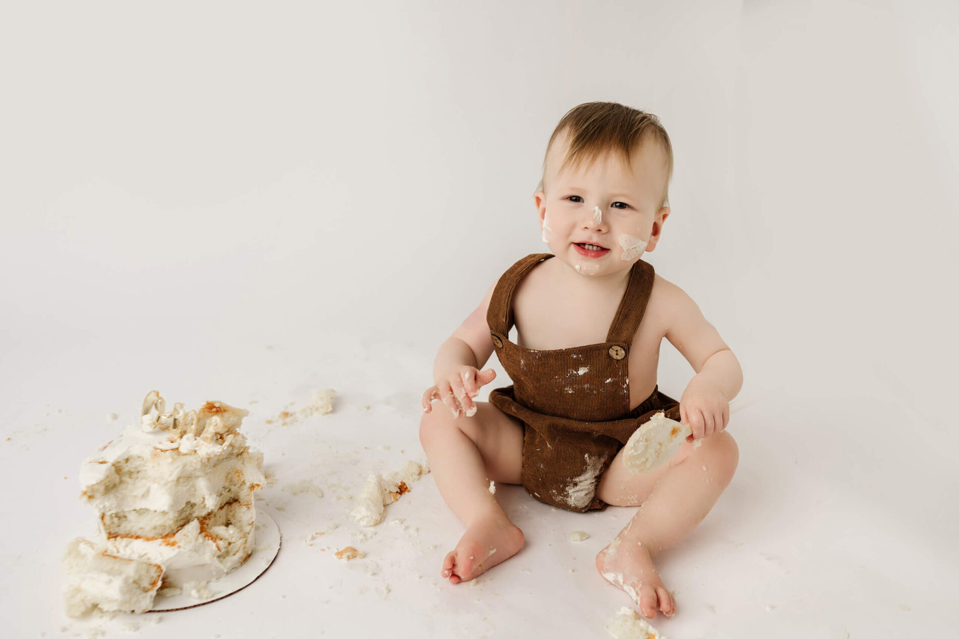 A moment during a cake smash session in a Seattle area studio