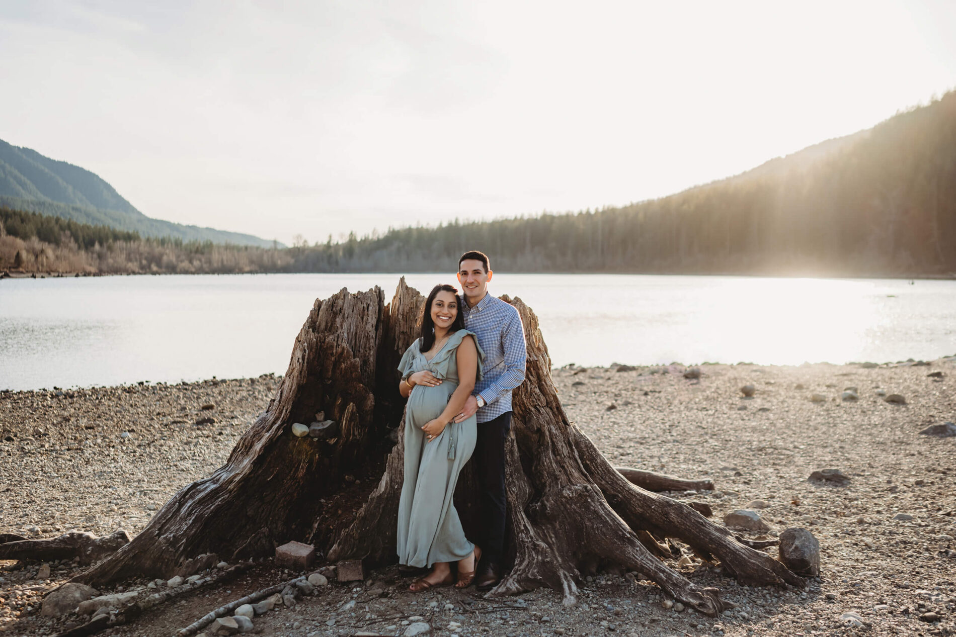 Young happy couple posed beautifully during a winter maternity photo shoot in the Cascade mountains