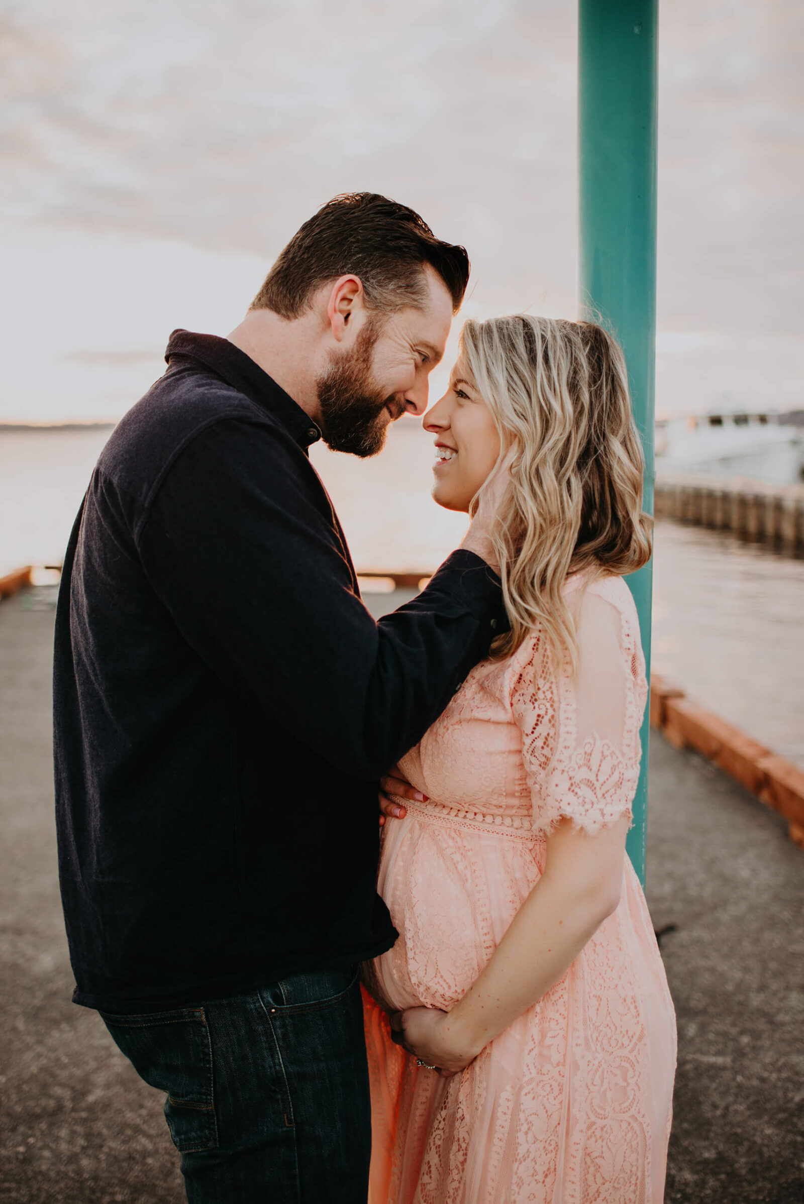 Happy couple posing during a winter maternity photo shoot in Kirkland, WA
