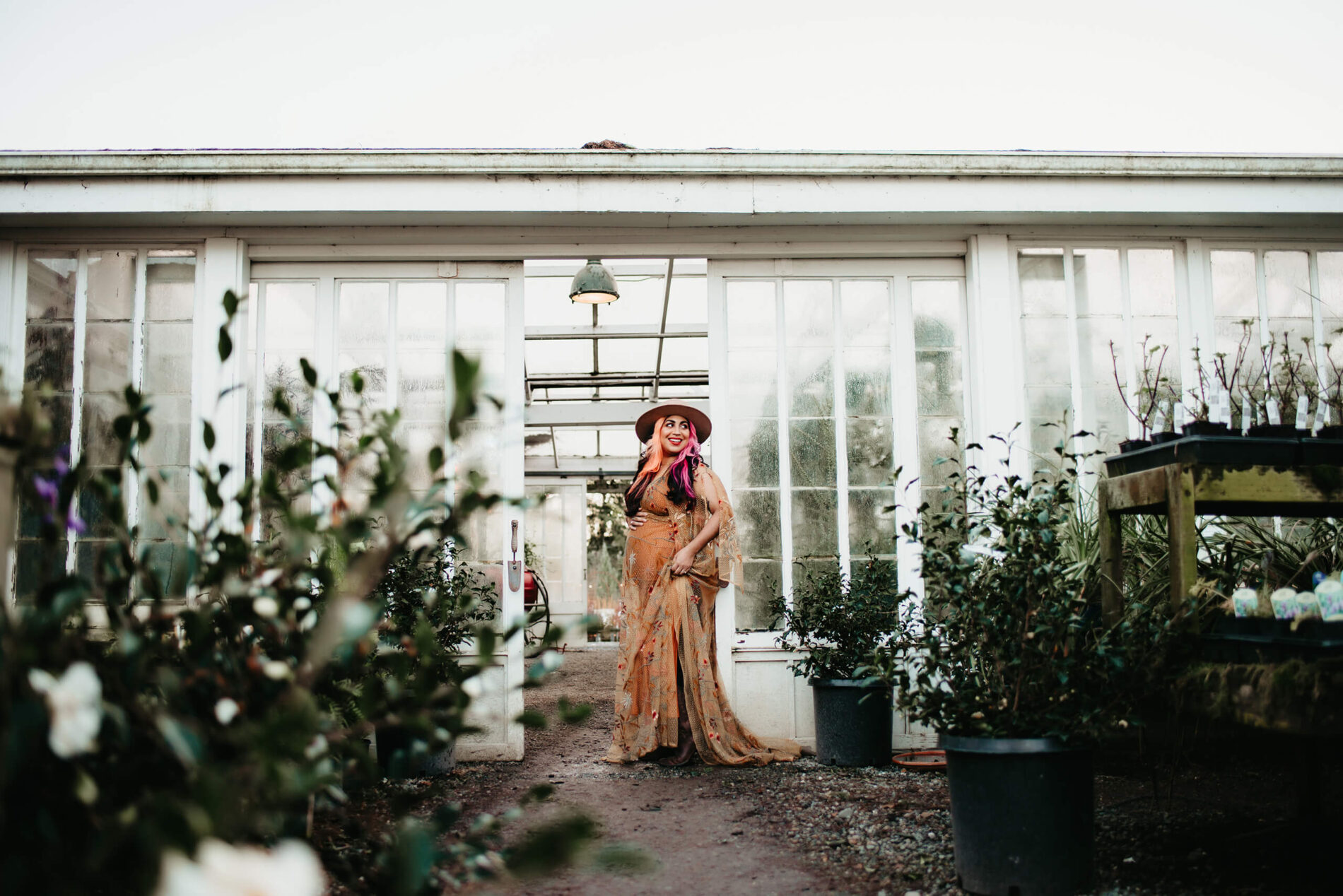 A smiling woman posing during a winter pregnancy photo shoot