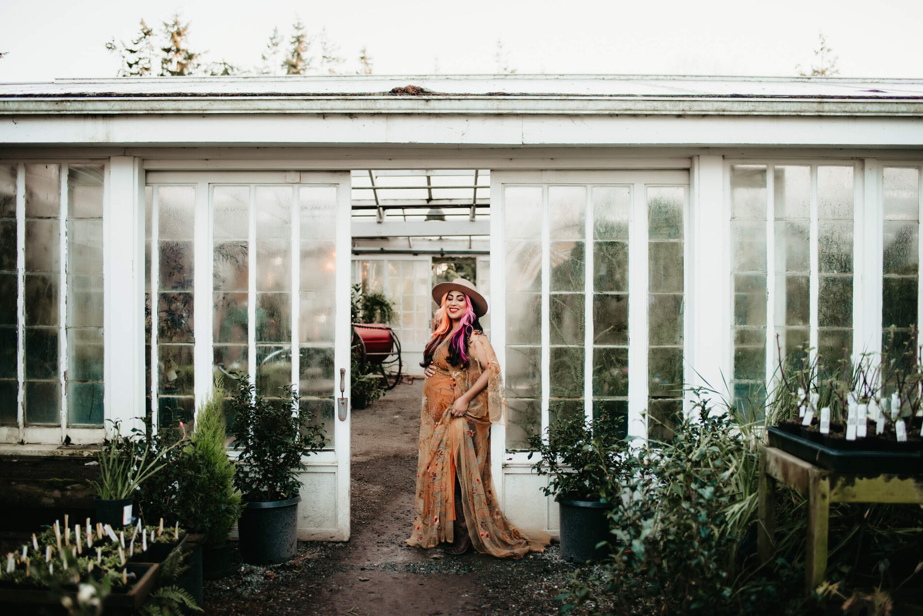 A smiling woman posing during a winter pregnancy photo shoot