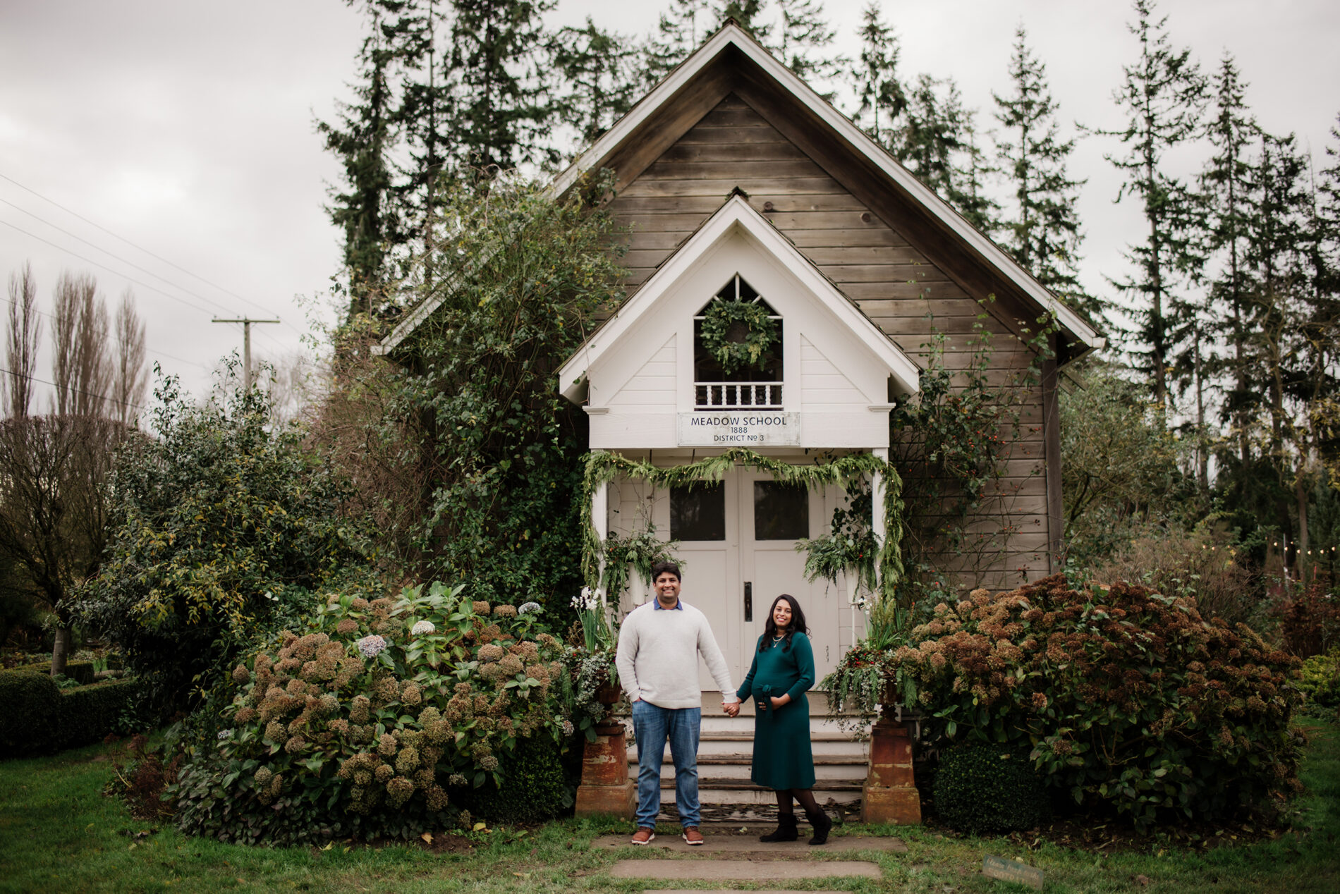 A couple posing during an outdoor winter maternity photo shoot