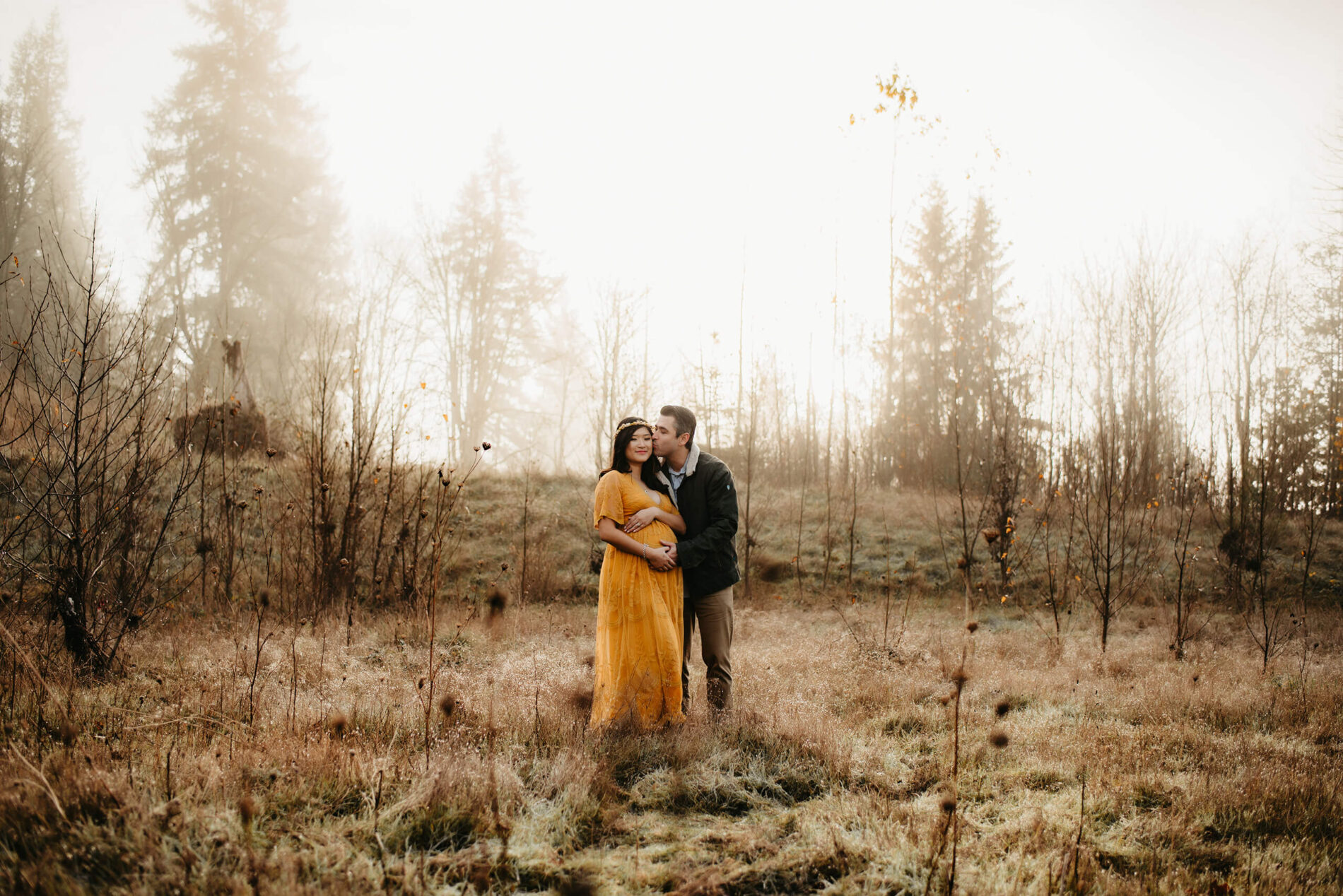 A couple posing during a winter maternity photo shoot