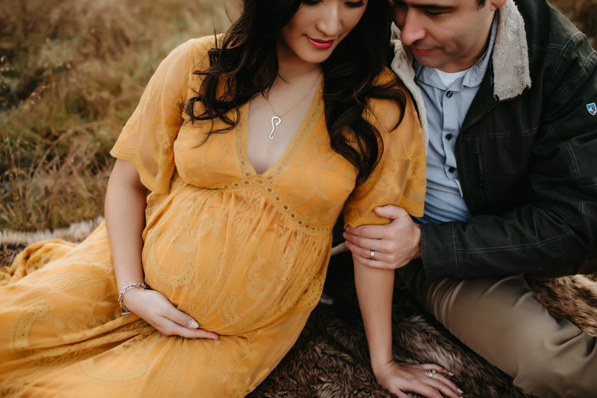 A couple posing during a winter maternity photo shoot