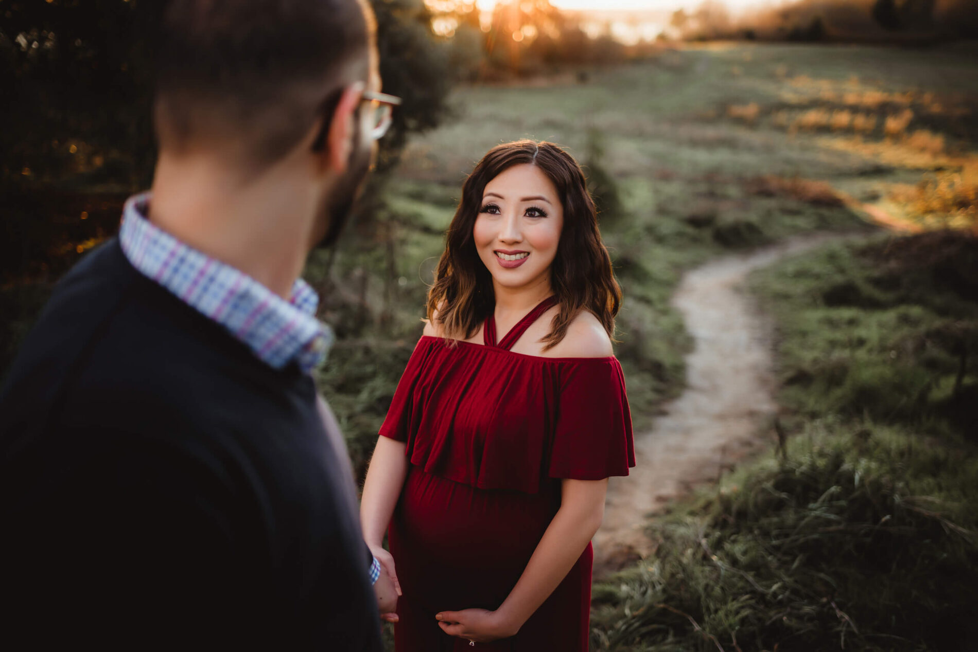 A moment during outdoor couple maternity photo shoot during winter