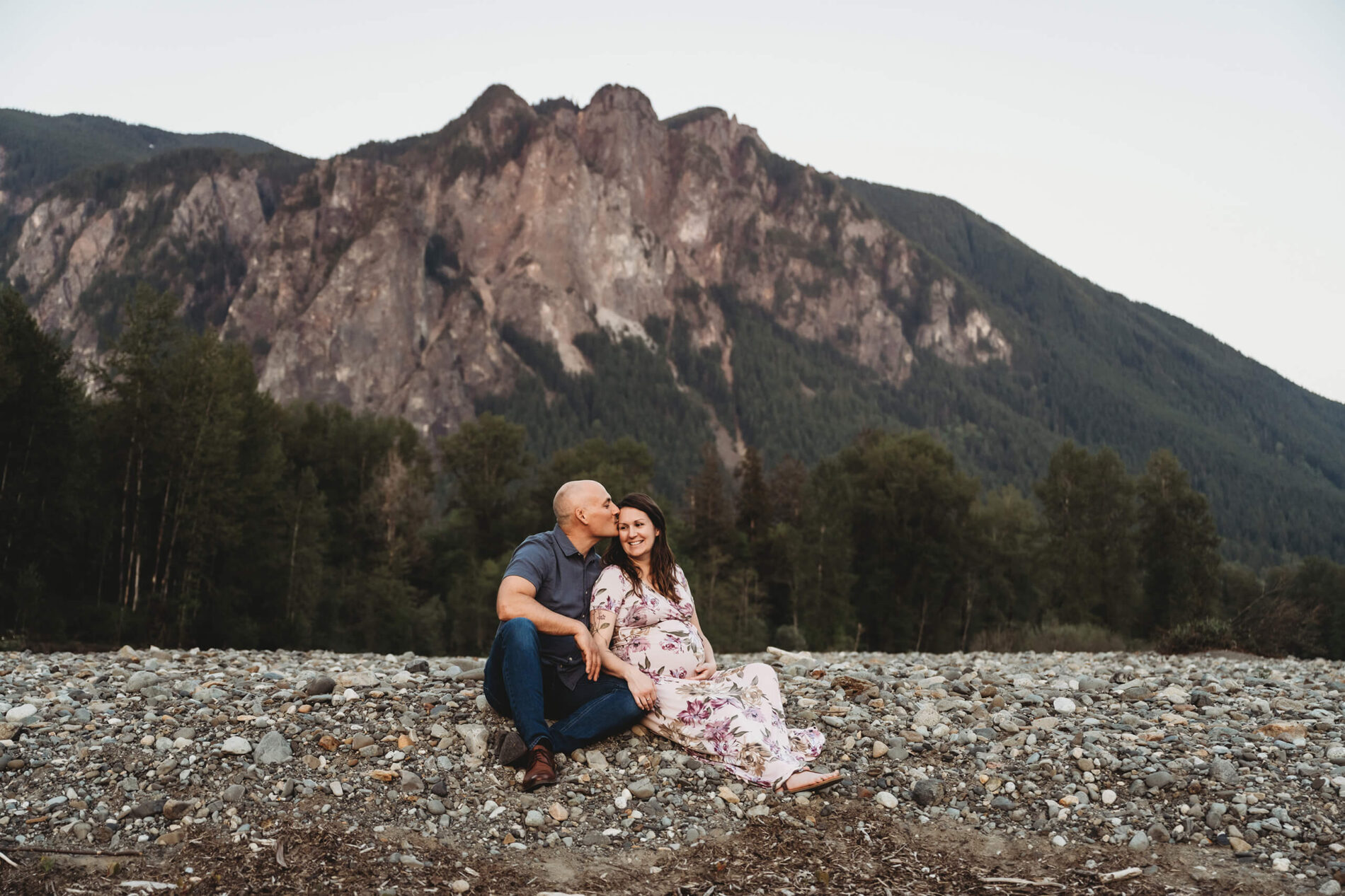 Couples pregnancy photo shoot in the Seattle area with mountains in the background