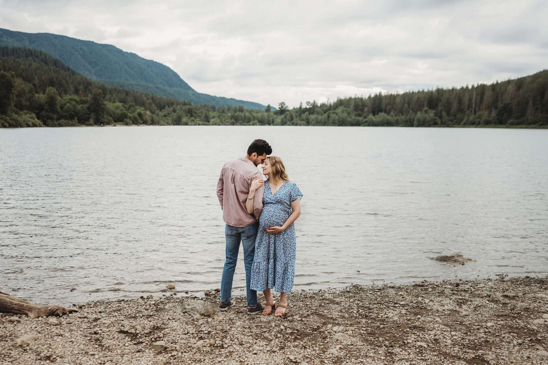 Couple posing during an outdoor pregnancy photo shoot in the Seattle area