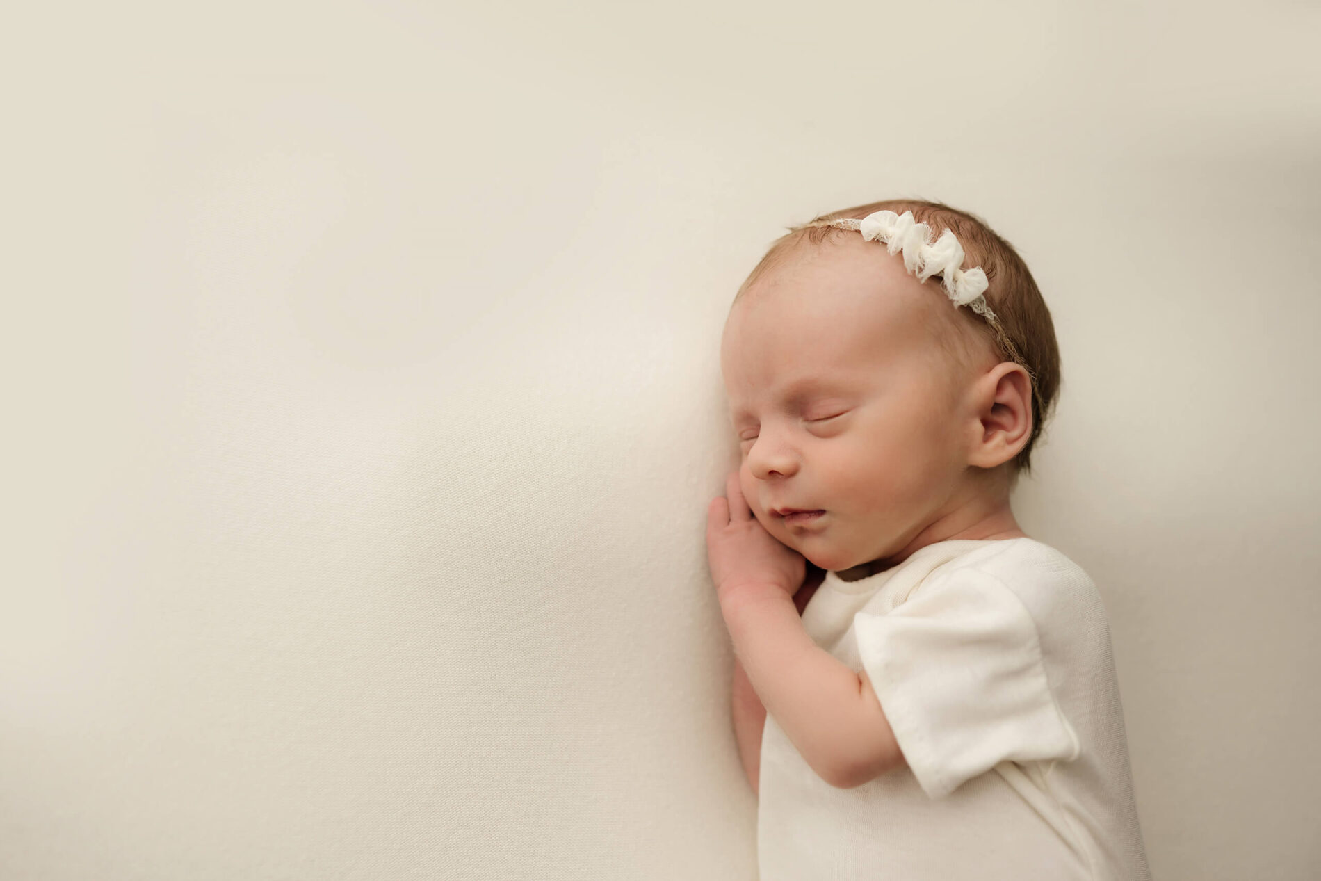 Newborn photography, focus on the face of sleeping baby girl