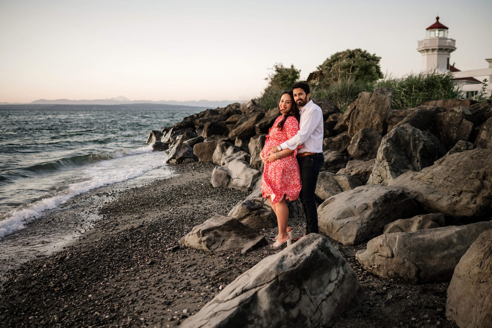Couple posing during maternity photo shoot at Seattle Discovery Park