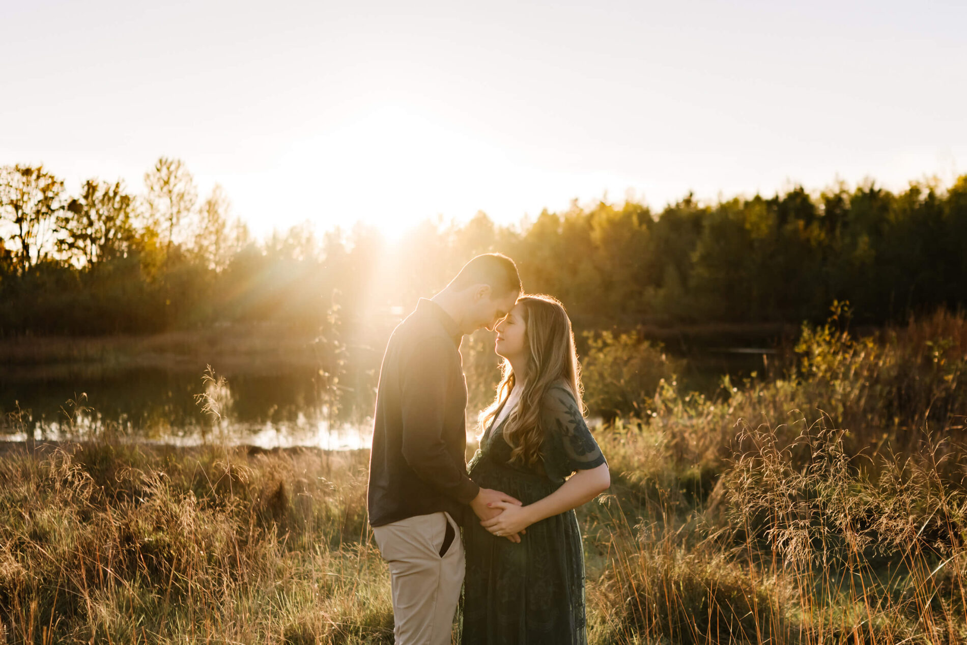 Couple maternity photo shoot in Bellevue during sunset, husband facing his wife, with their heads touching