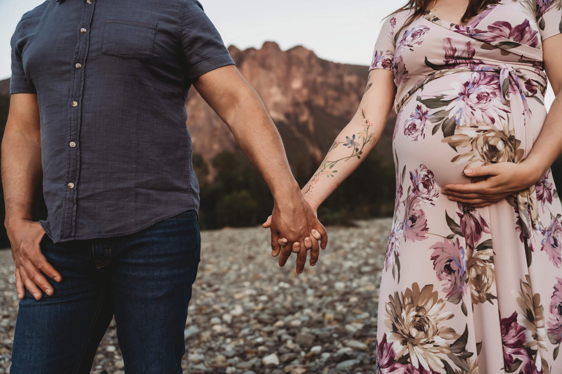 Couple holding hands during Seattle maternity photo shoot