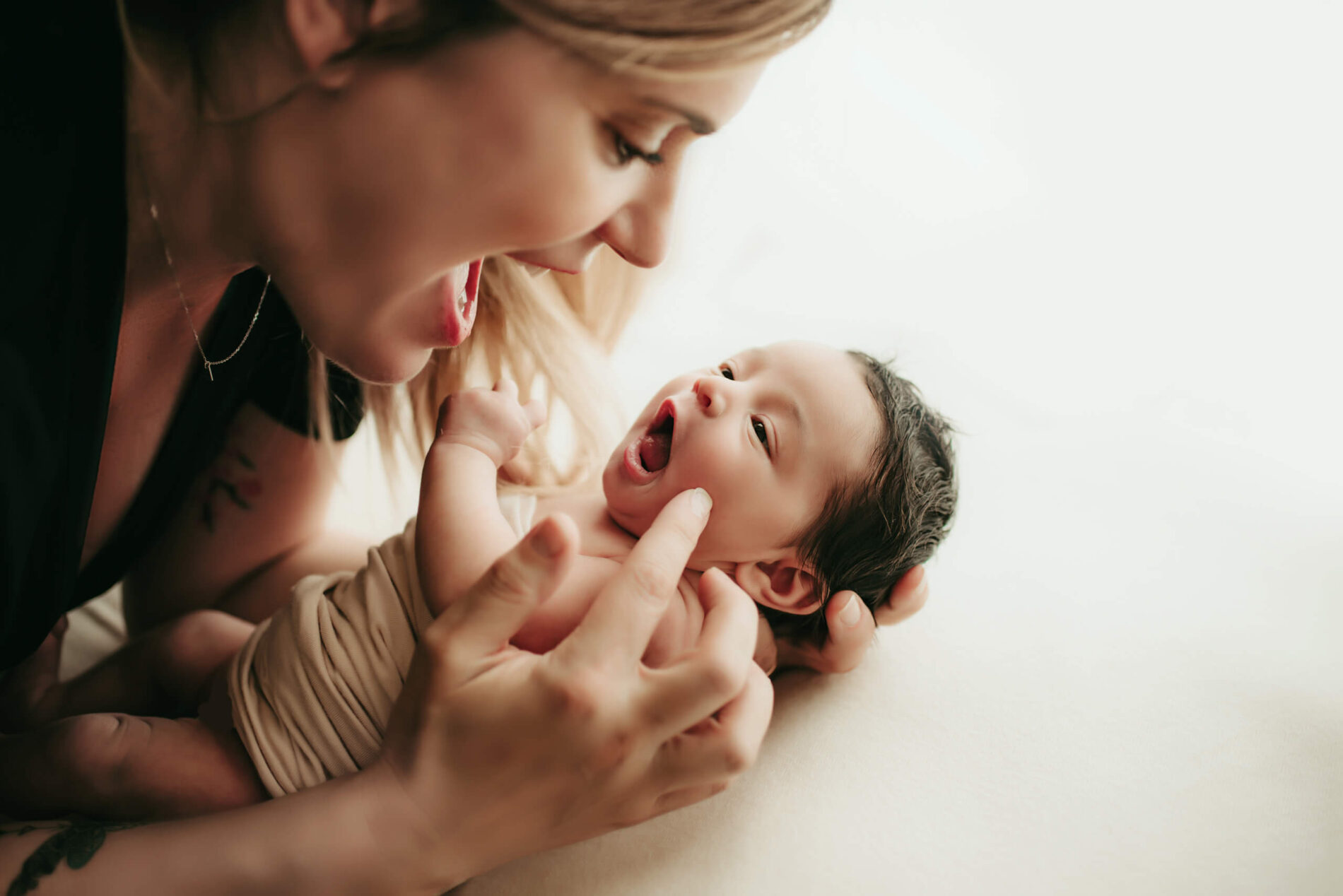 Seattle newborn photography, mom cuddling and interacting with her baby girl