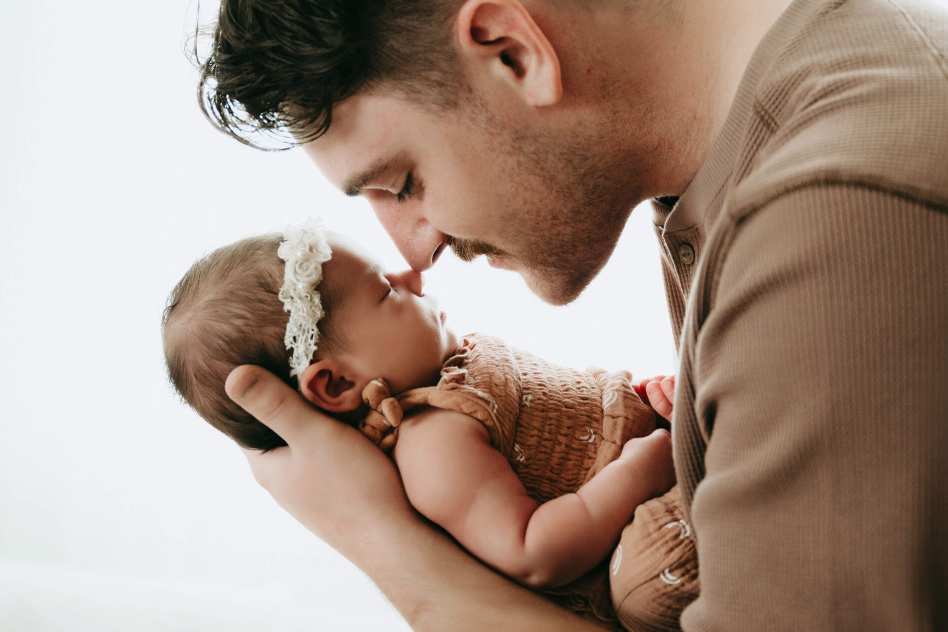 Seattle newborn photographer posing a dad with newborn daughter