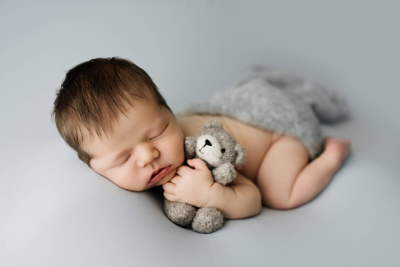 A posed shot of a newborn boy from a studio newborn session